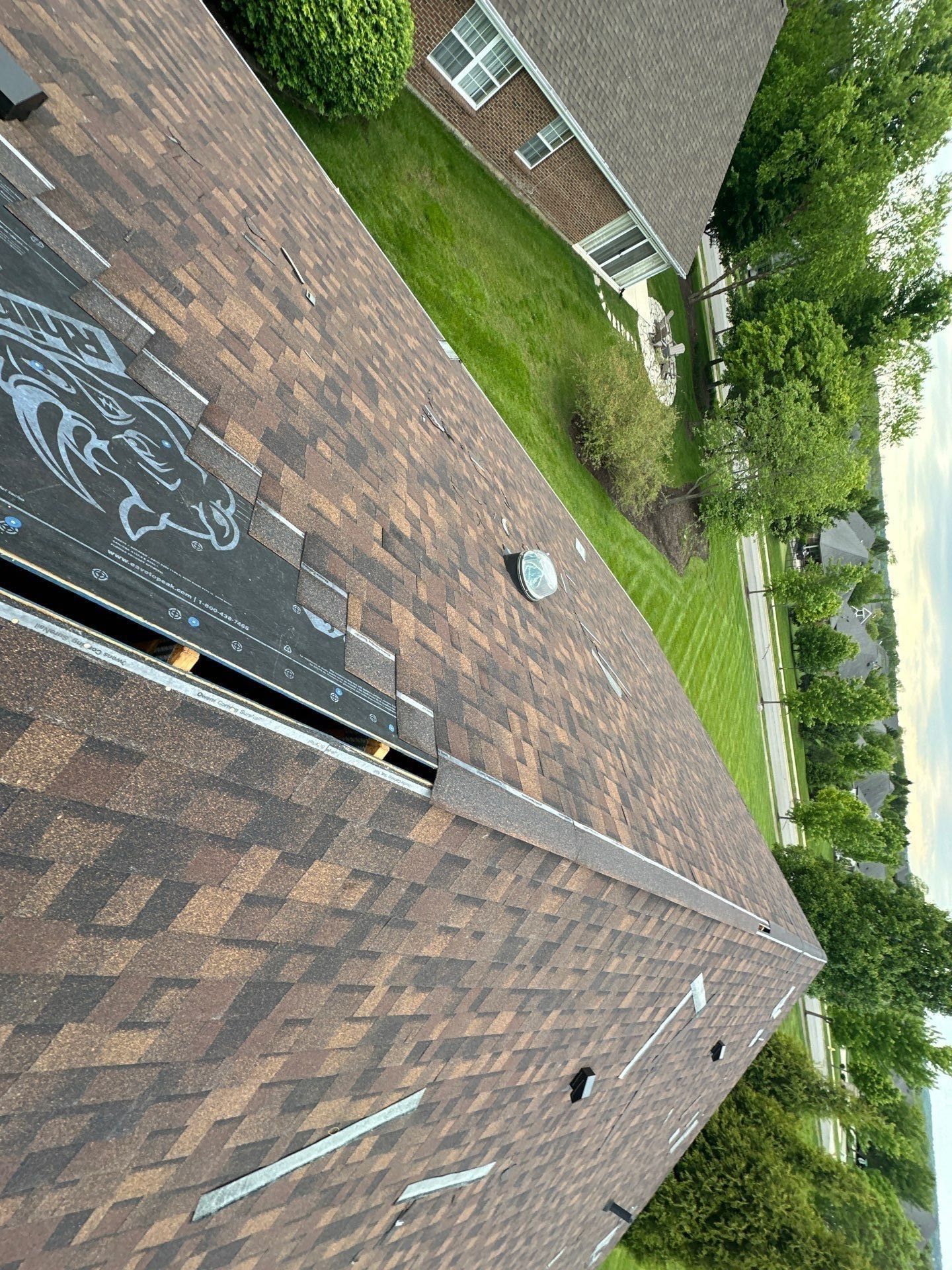 Shingles up to an open ridge slot cut