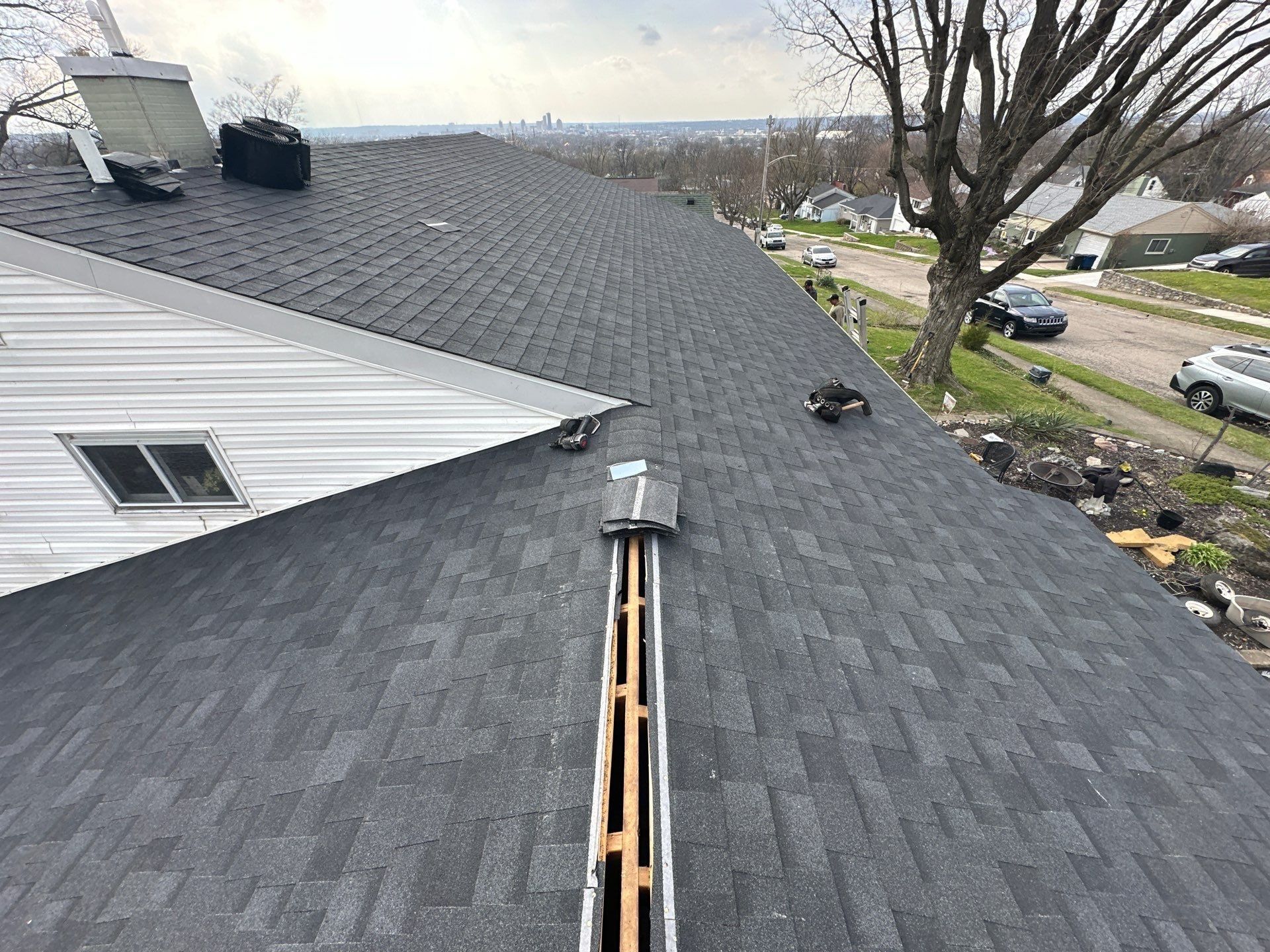New shingles on both sides of the open ridge before the vent, Dayton, Ohio.