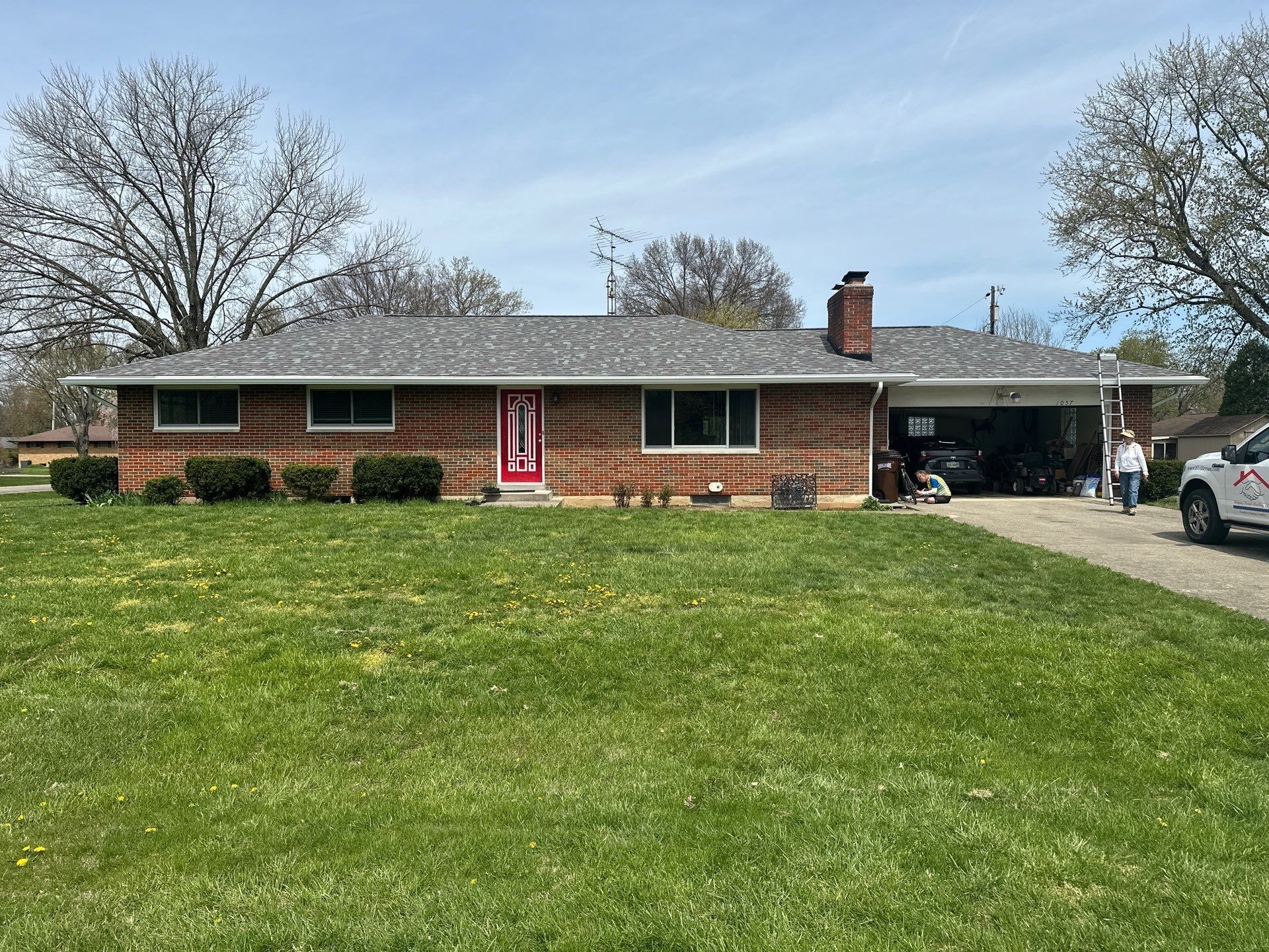 Front of the brick ranch house with its finished new roof, Beavercreek, Ohio.