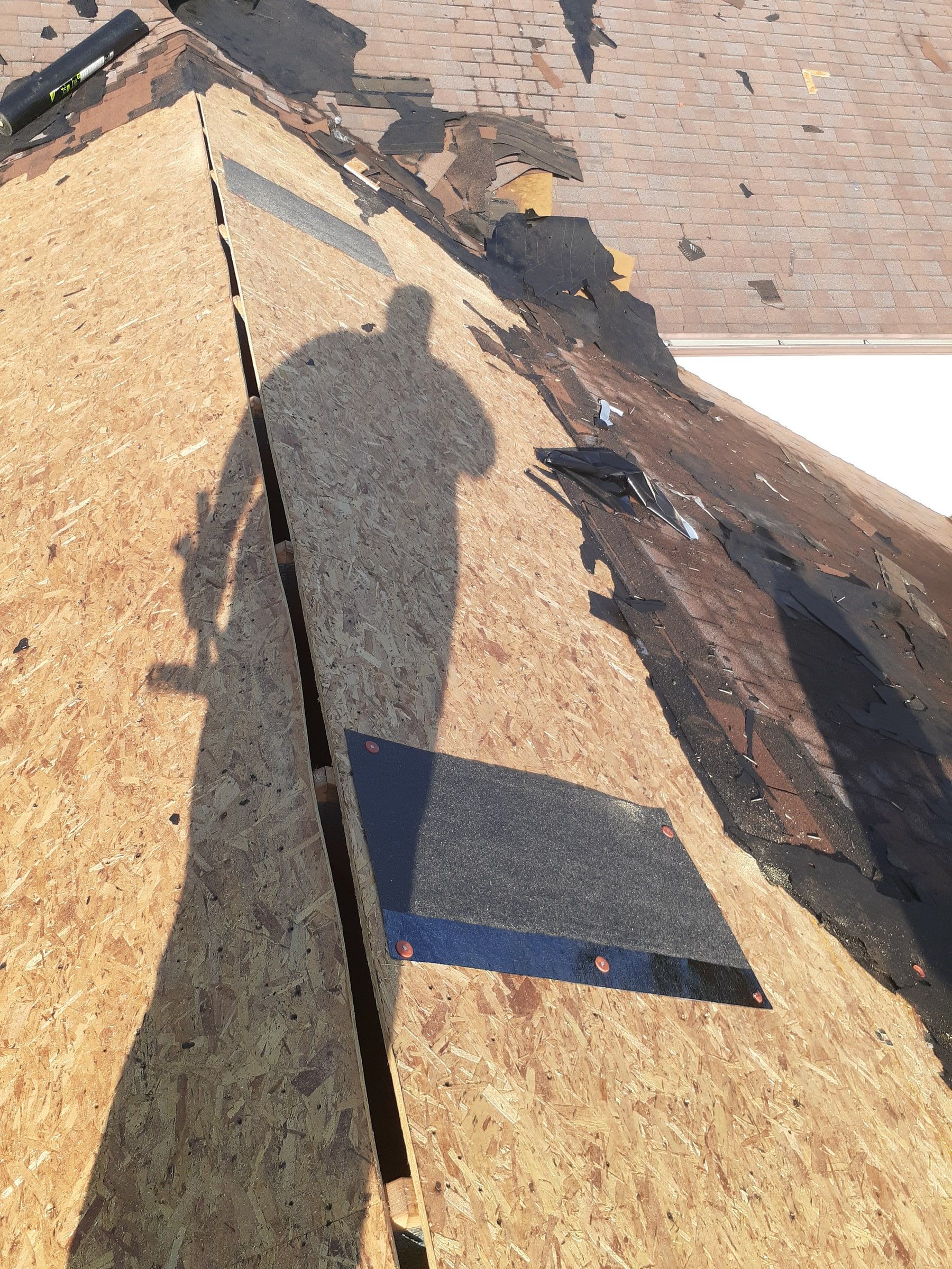 Bare original deck with an old vent opening covered after tear-off, Jamestown, Ohio.
