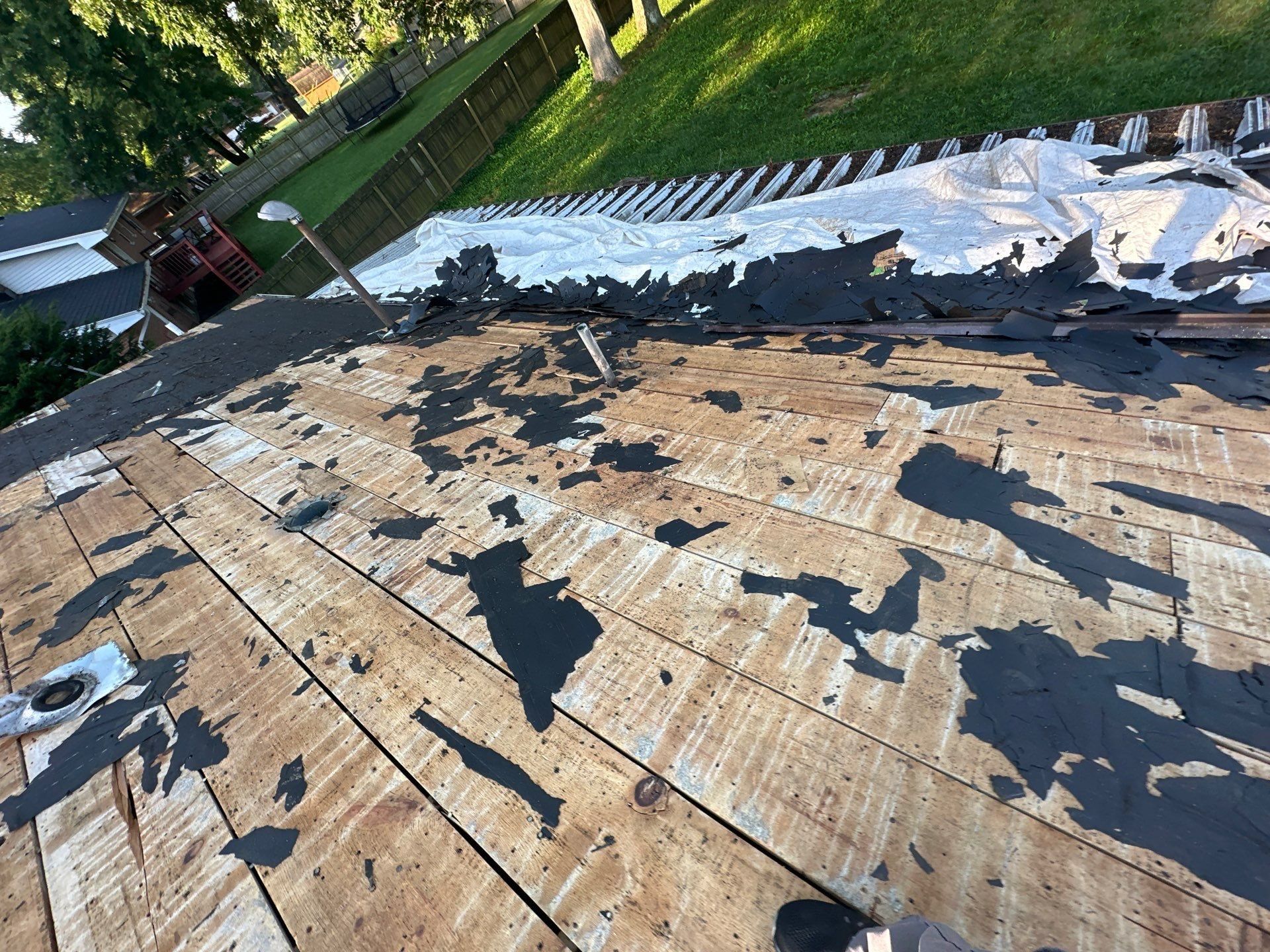 Old shingles stripped away to expose plank board decking and leftover paper, Beavercreek, Ohio.