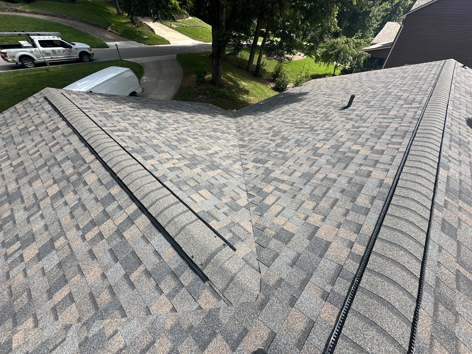 The finished hips and ridge vent above the driveway, Beavercreek, Ohio.