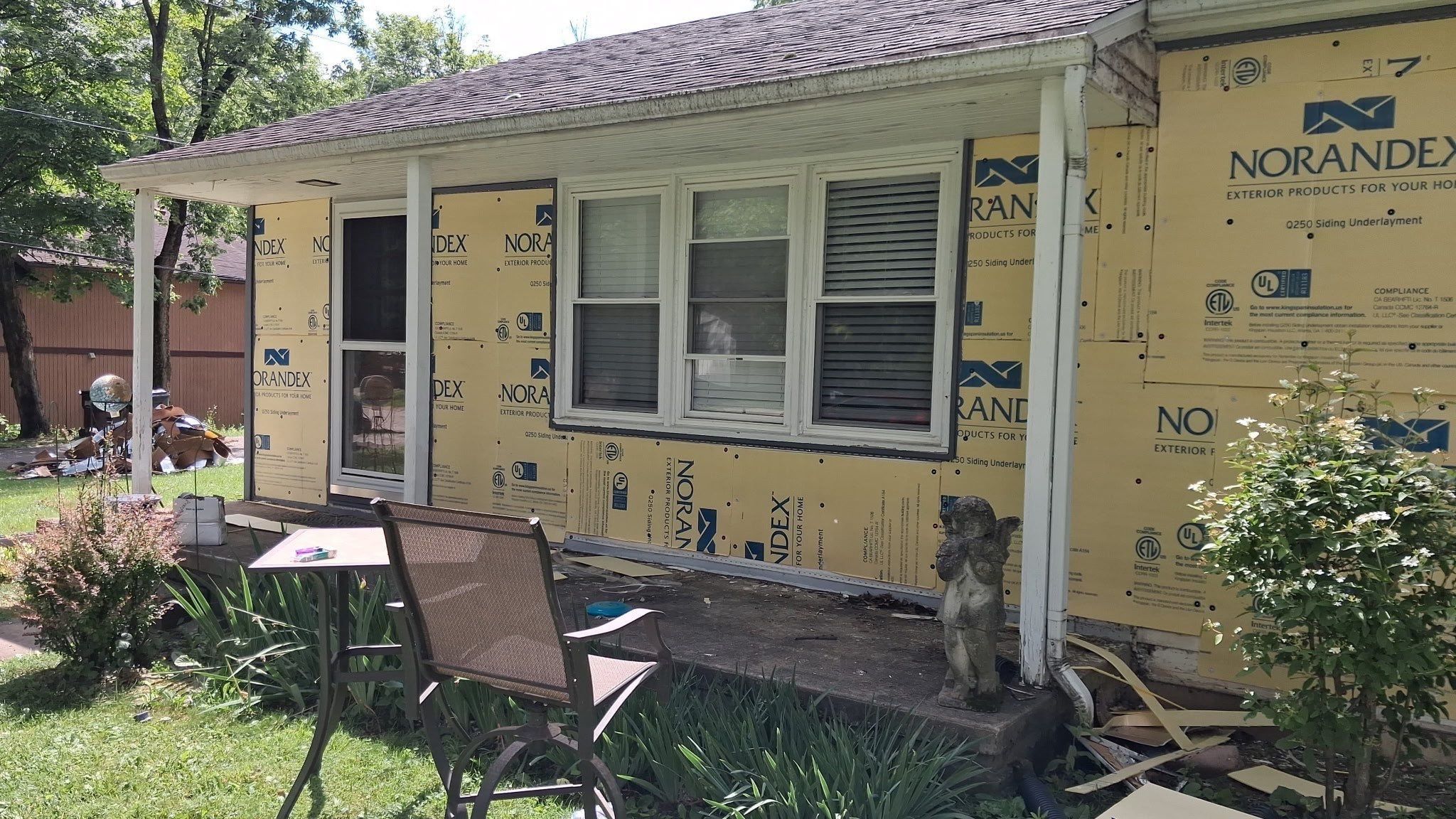 Siding underlayment board and cut-in windows