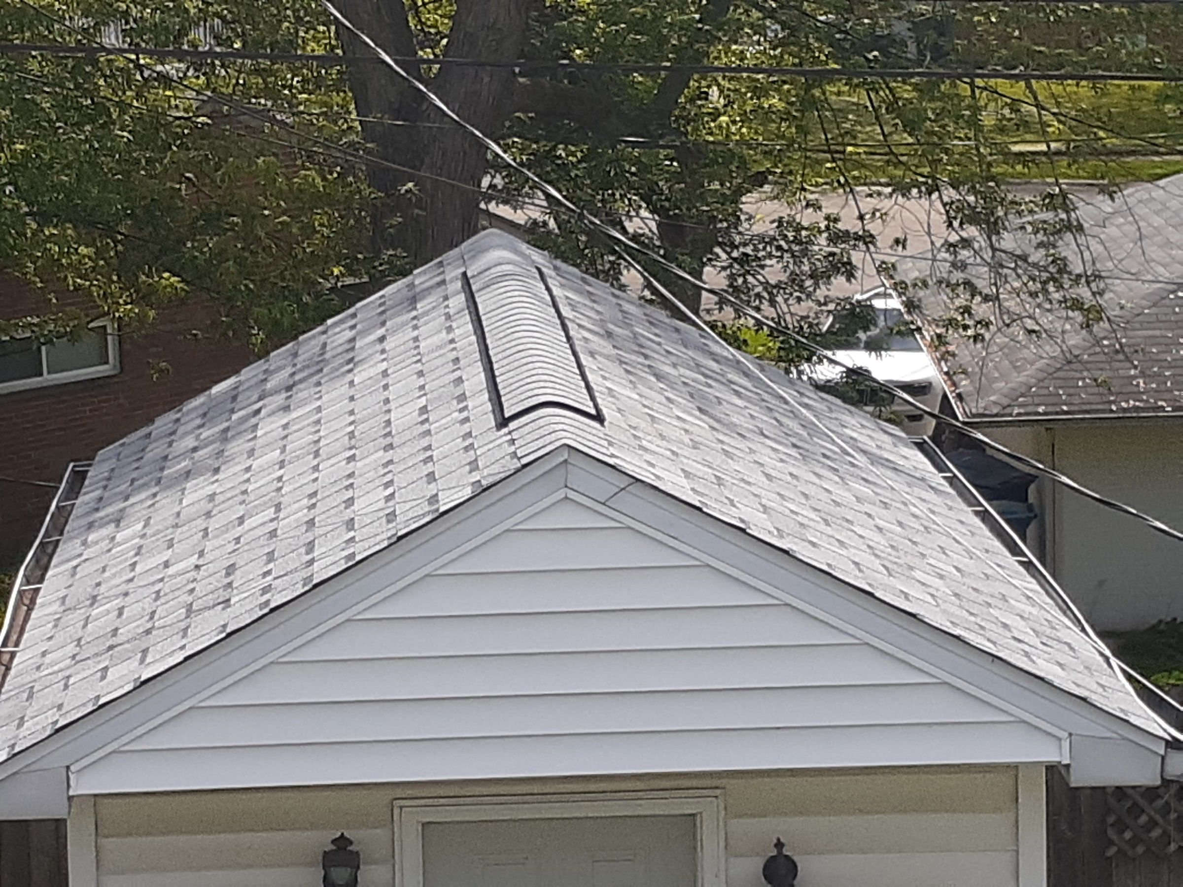 The finished garage roof with ridge vent above the door, Huber Heights, Ohio.