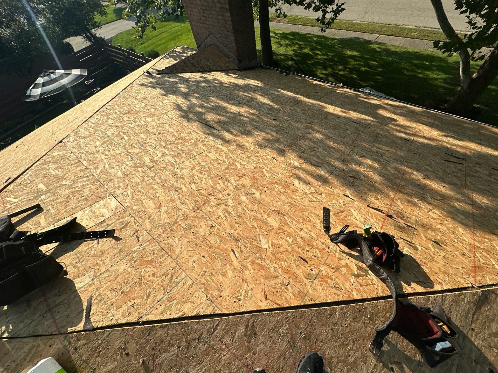 The clean deck below the brick chimney, with tools lying on it, Dayton, Ohio.