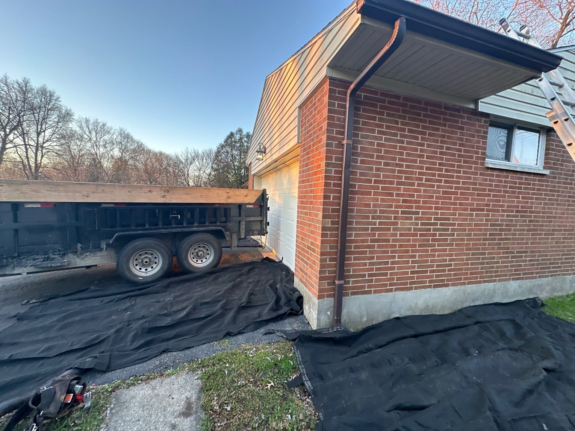 Dump trailer and tarped driveway
