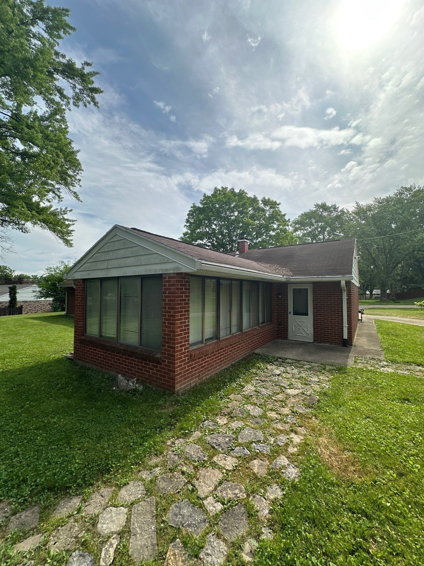 Brick ranch, sun room and flagstone path