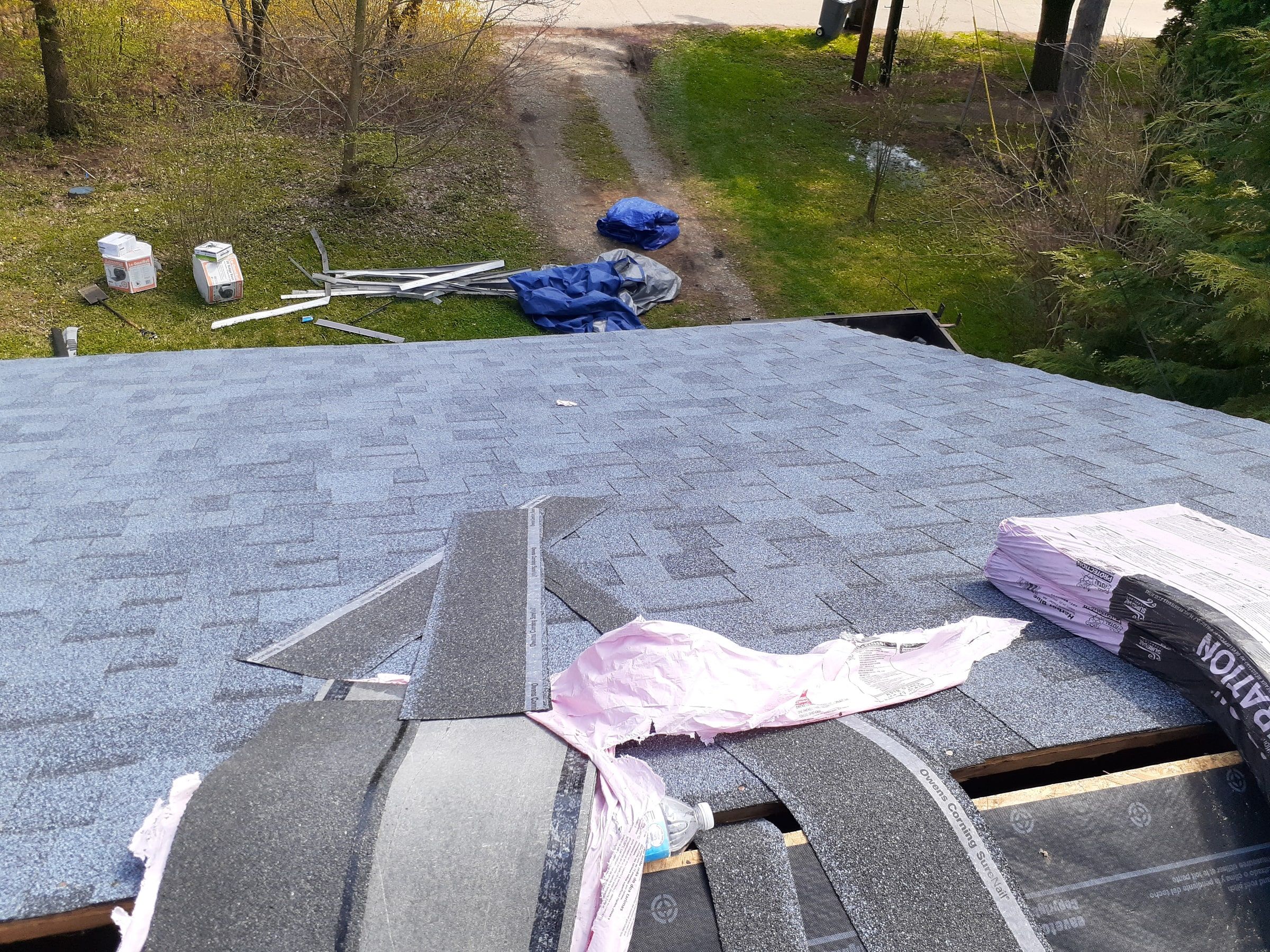 Ridge cap shingles laid out along the open ridge, Yellow Springs, Ohio.