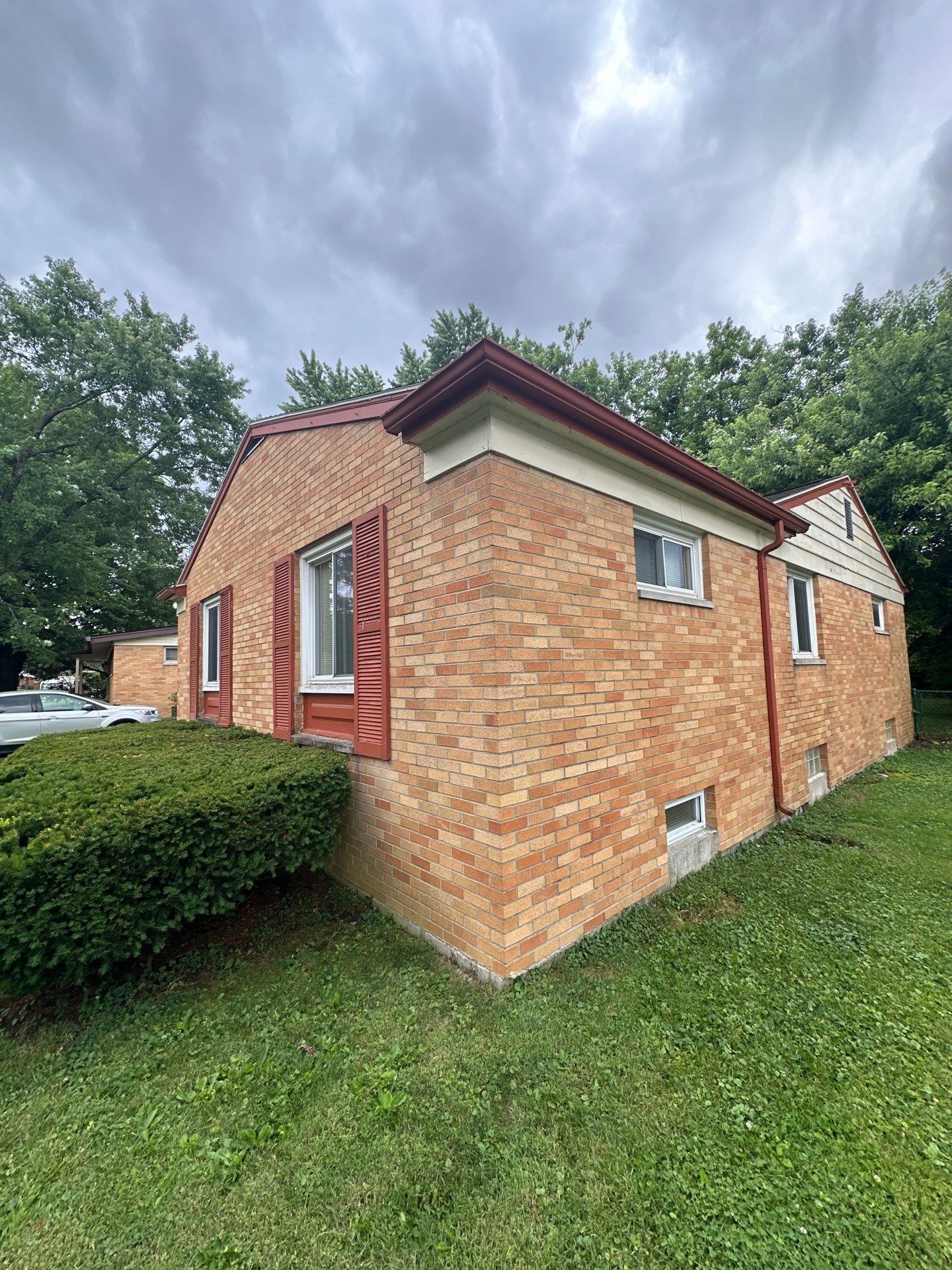 Side of the house and red gutter