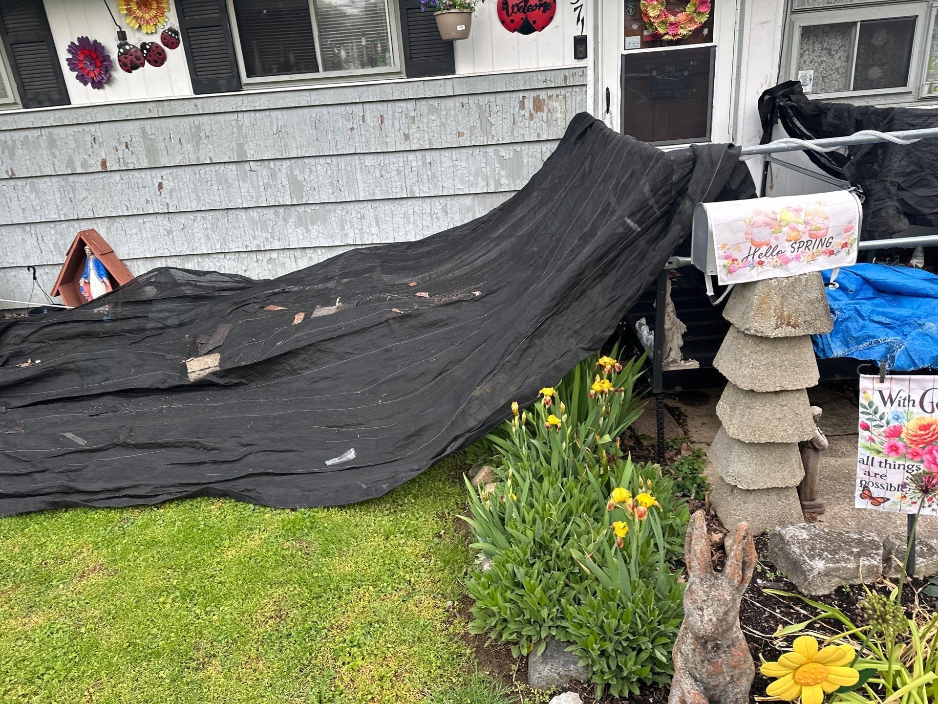 Ground tarps over flower beds and patio
