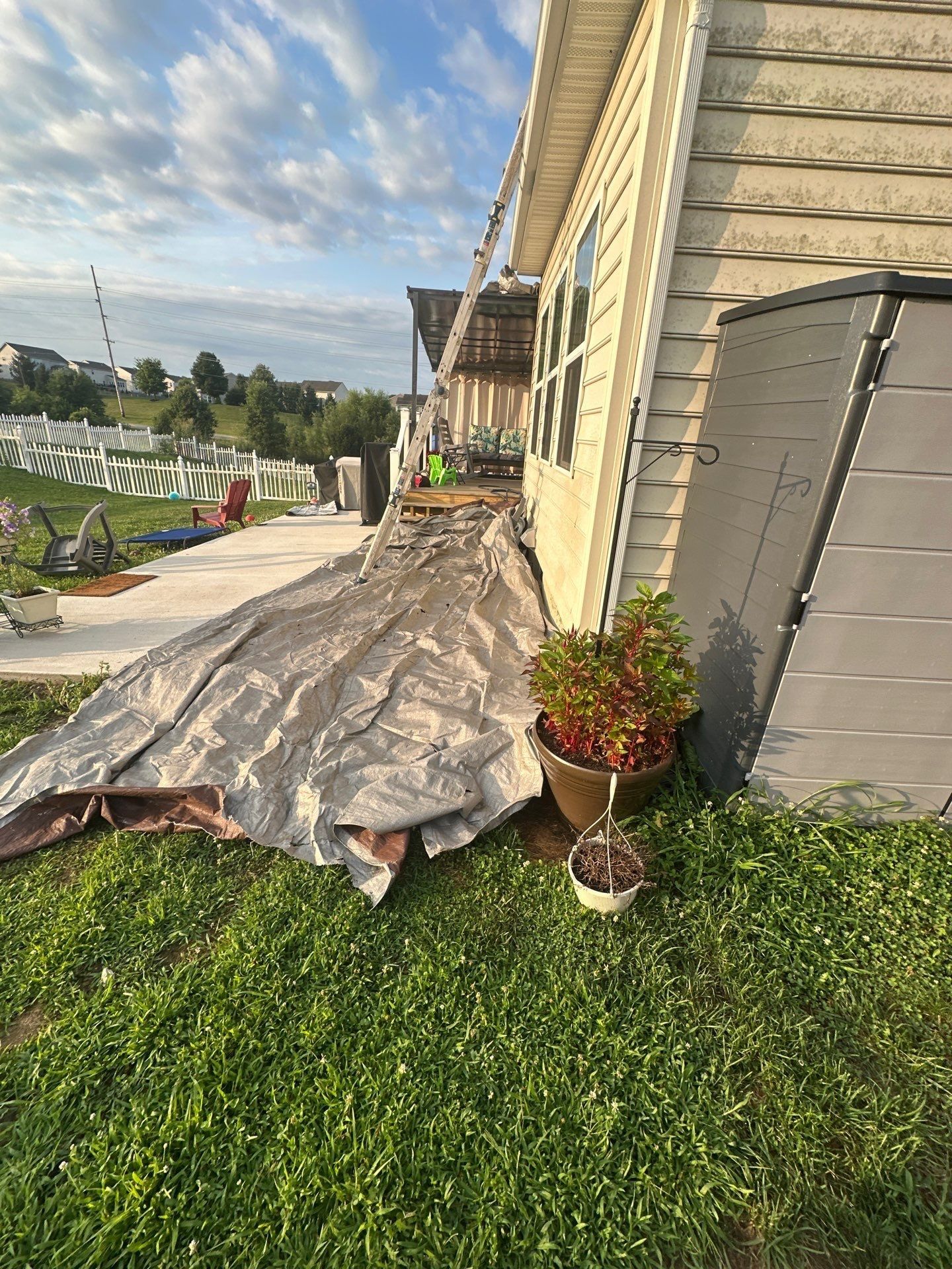 A tarp laid along the back of the house beside the patio, Xenia, Ohio.