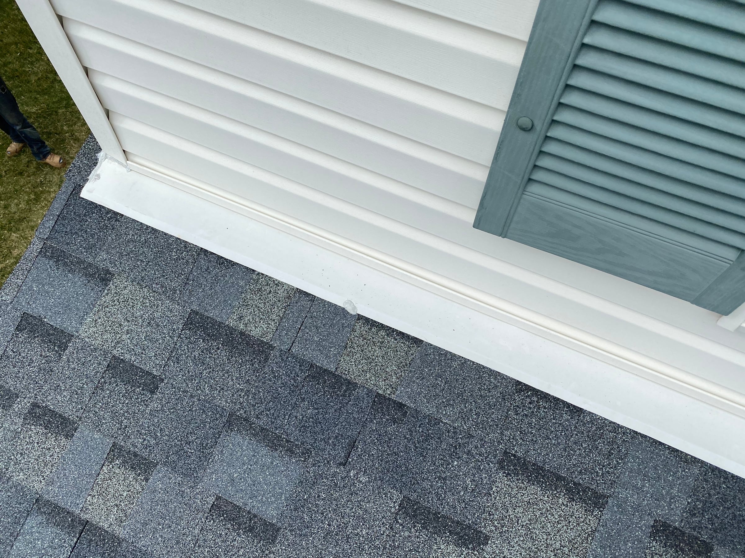 Shingles at the white trim and louver