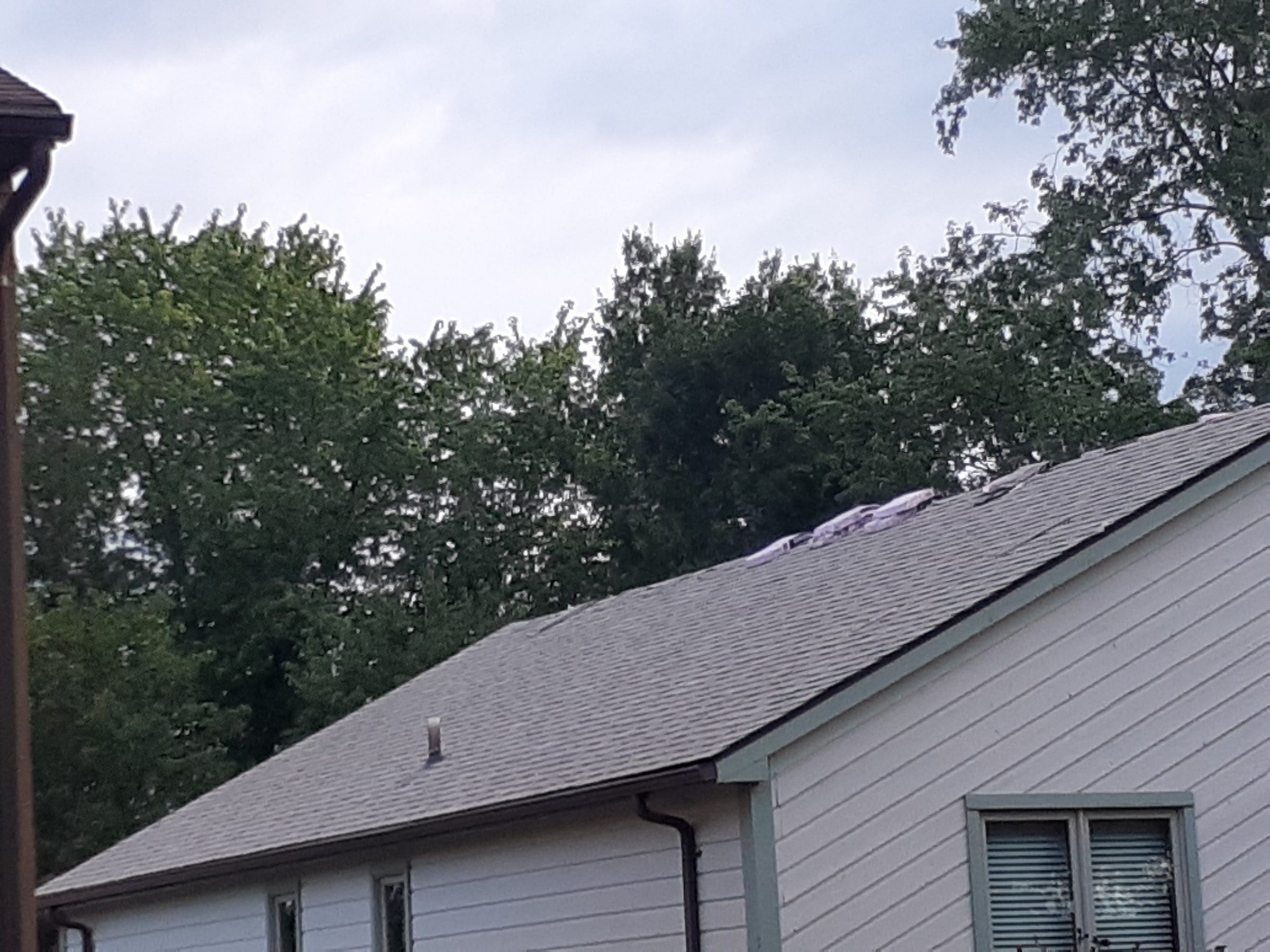 Side gable shingled with a pipe vent and bundles at the ridge, Jamestown, Ohio.