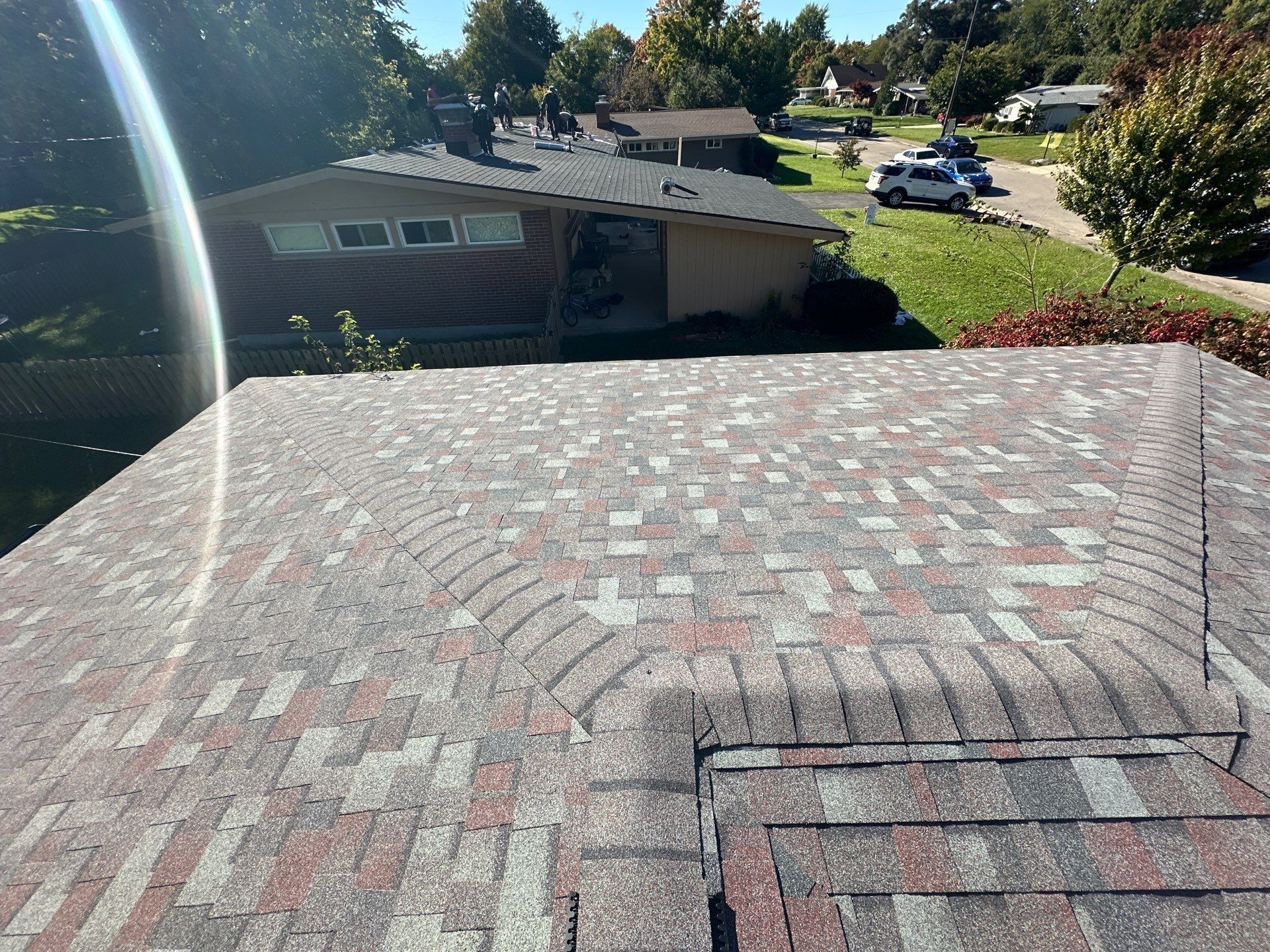 The finished lower roof with ridge caps on the hips, above the street, Kettering, Ohio.