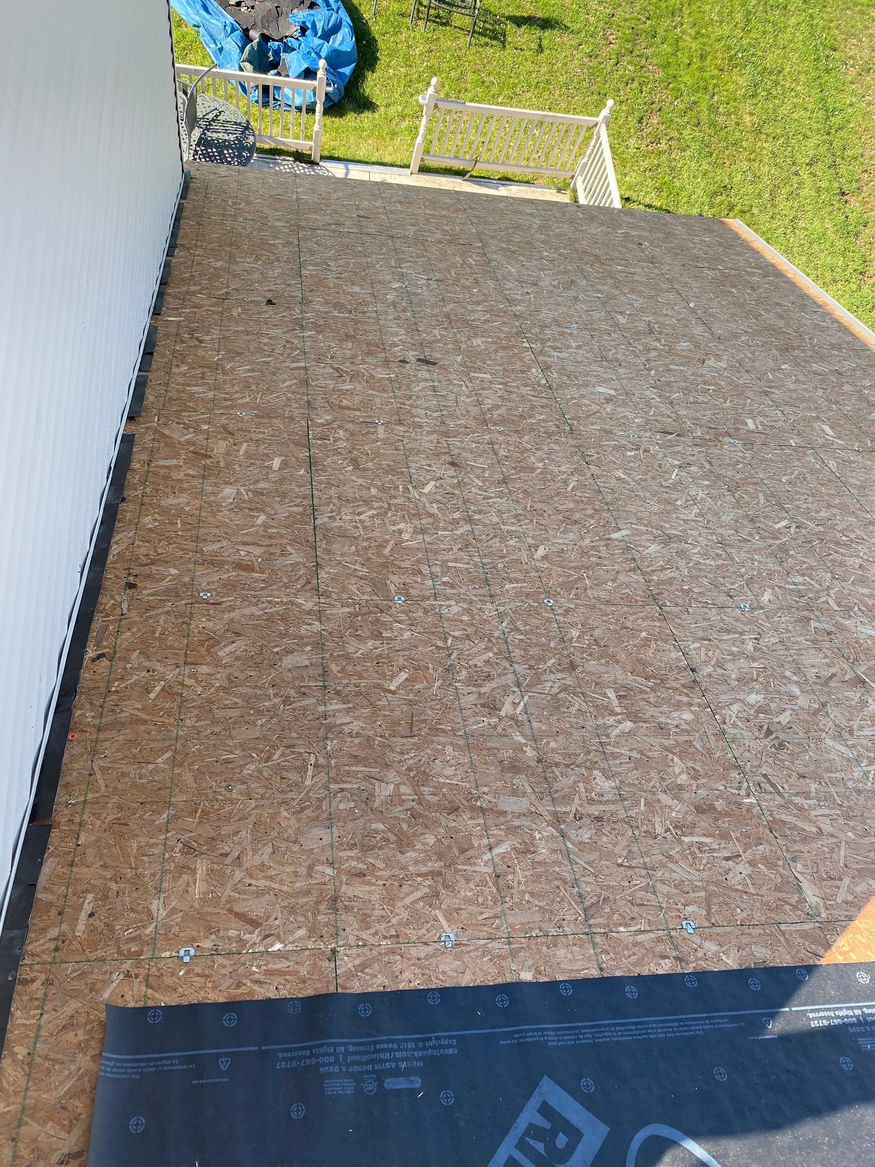 Bare OSB roof deck swept clean beside the upper wall, ready for underlayment, Xenia, Ohio.