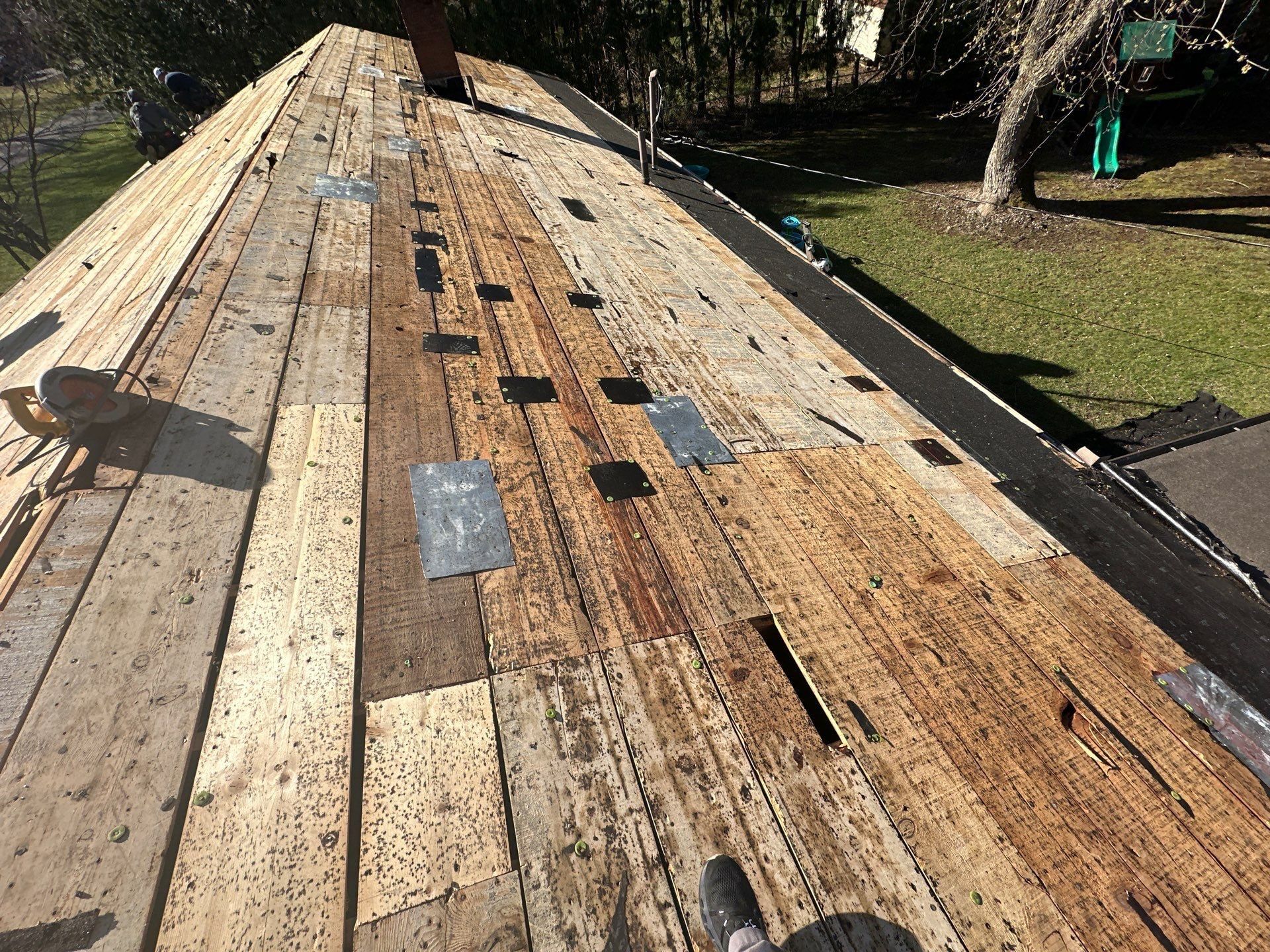Plank decking with metal patches nailed over