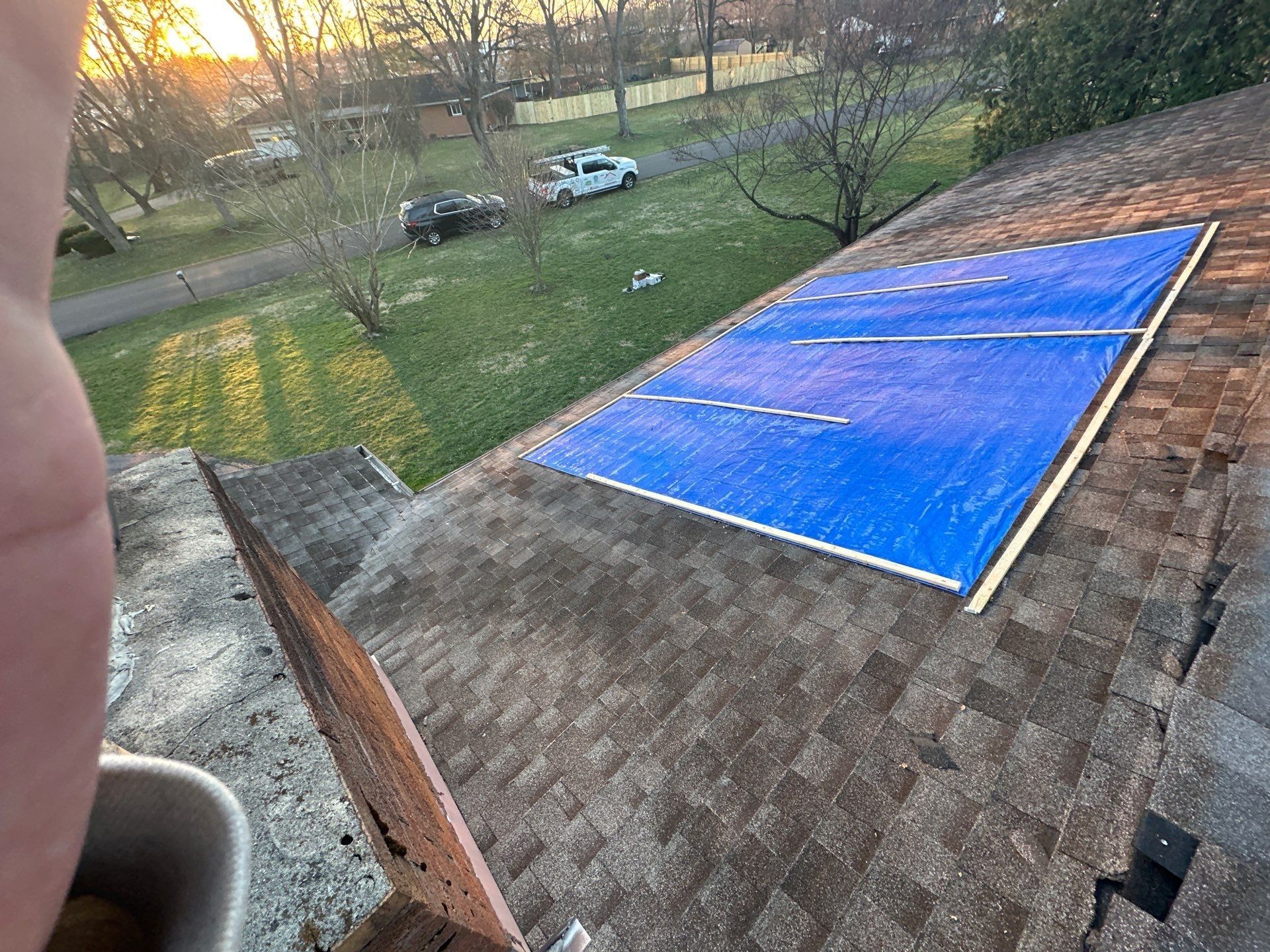 The emergency tarp seen across the roof at sunset, Beavercreek, Ohio.