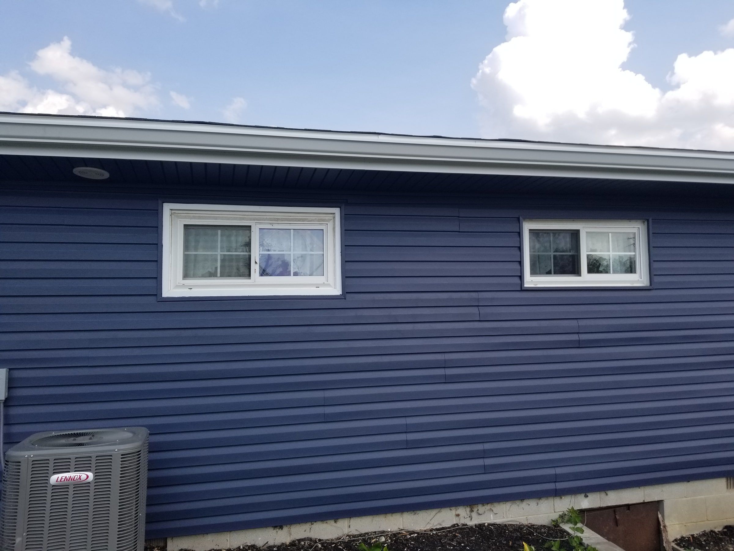 The back wall in blue siding with its two windows, Beavercreek, Ohio.
