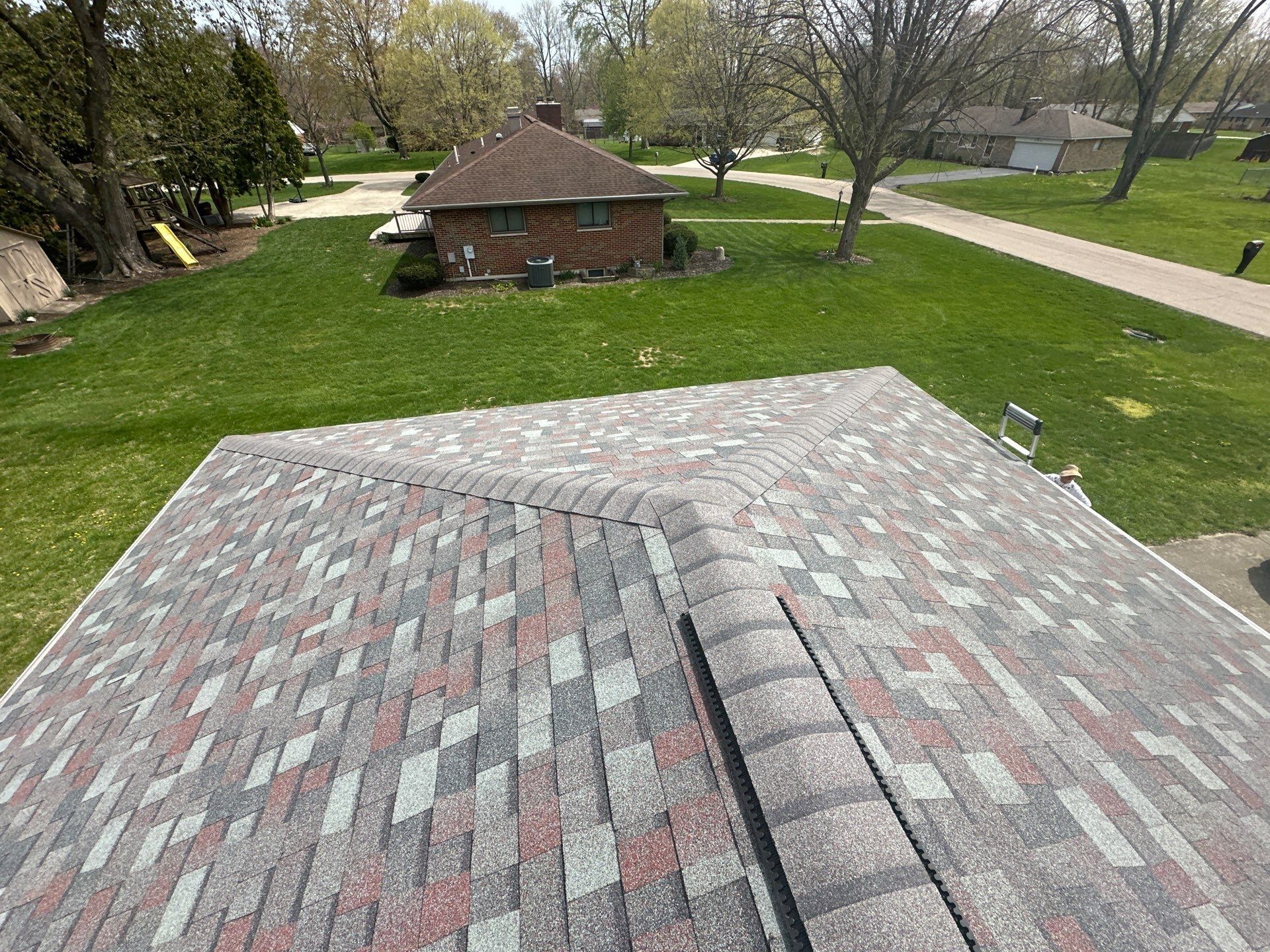 Finished hip end of the roof with fresh ridge caps, Beavercreek, Ohio.