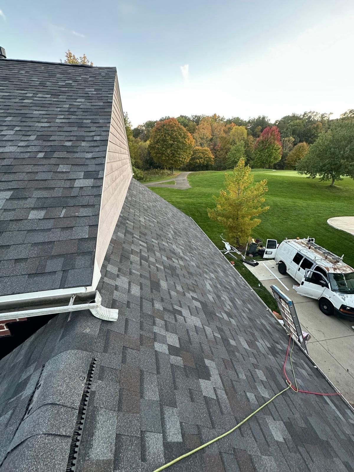 New shingles running down beside the siding wall to the gutter, Beavercreek, Ohio.