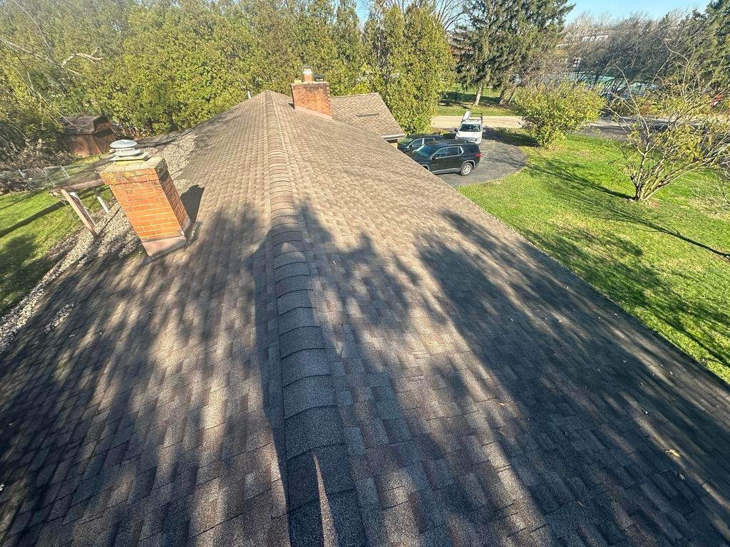 Tan weathered roof and brick chimney