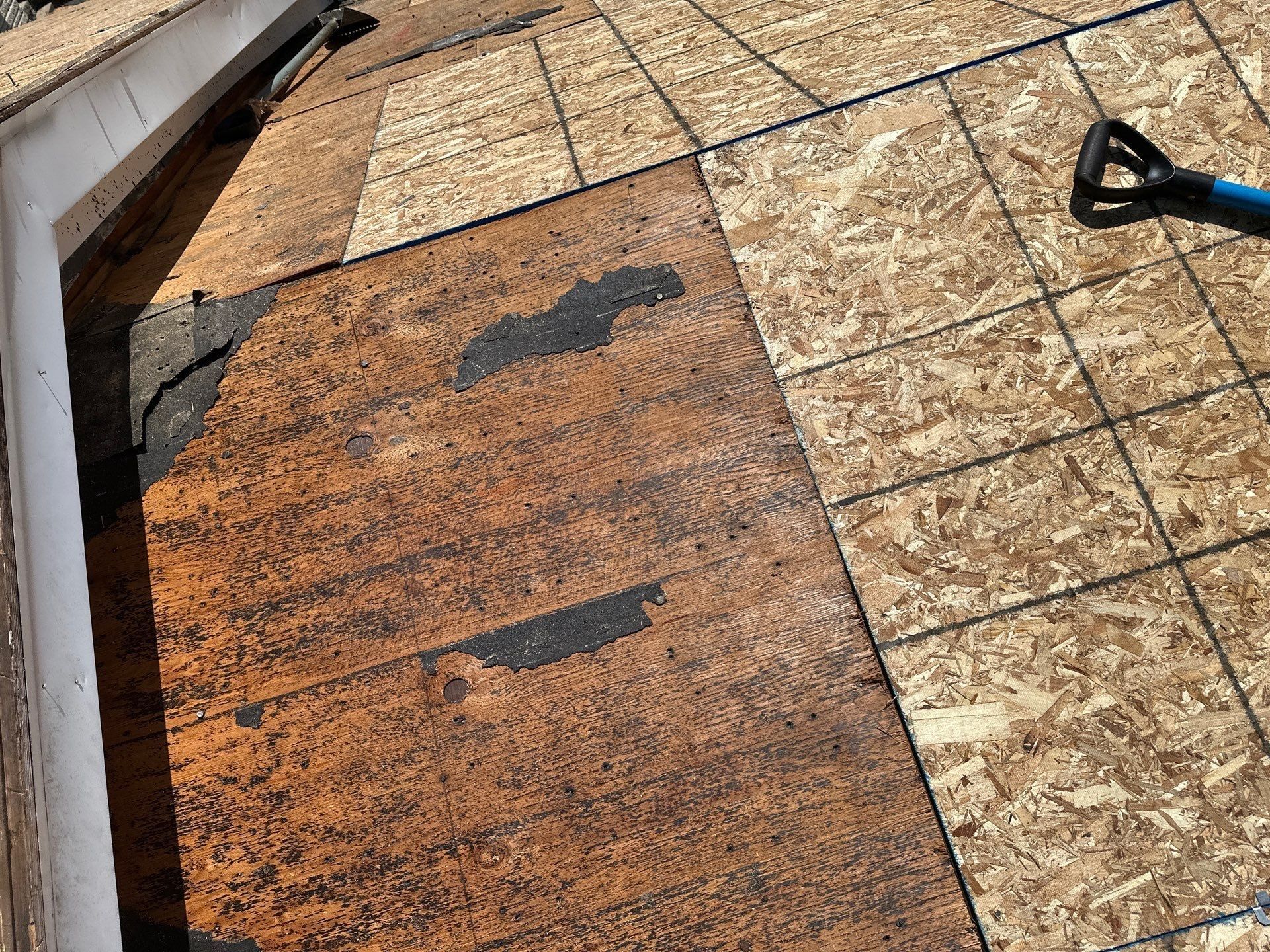 The old dark plywood deck next to sheets of new OSB, Beavercreek, Ohio.