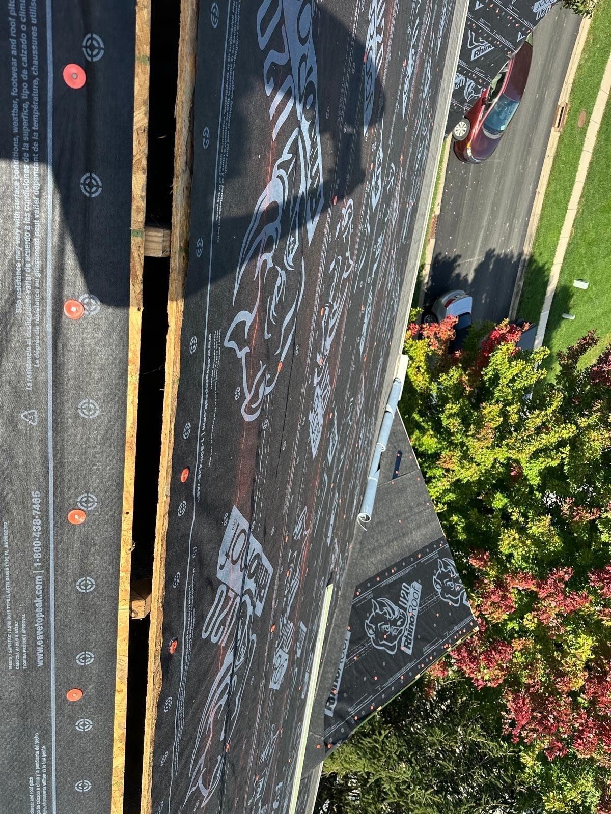 The open ridge slot cut for the ridge vent, between two slopes of underlayment, Beavercreek, Ohio.