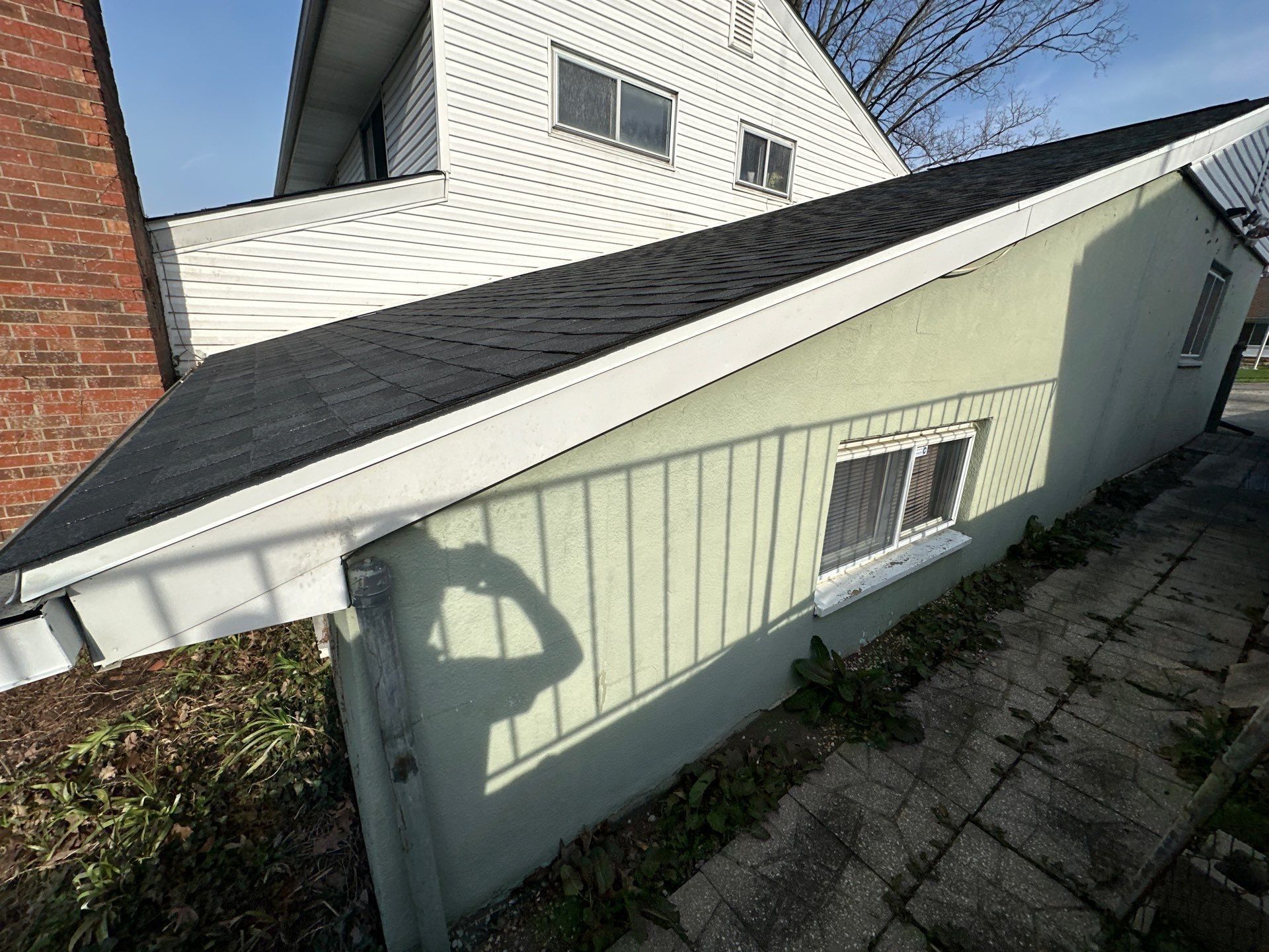 Porch roof and gutter on mint-green wall