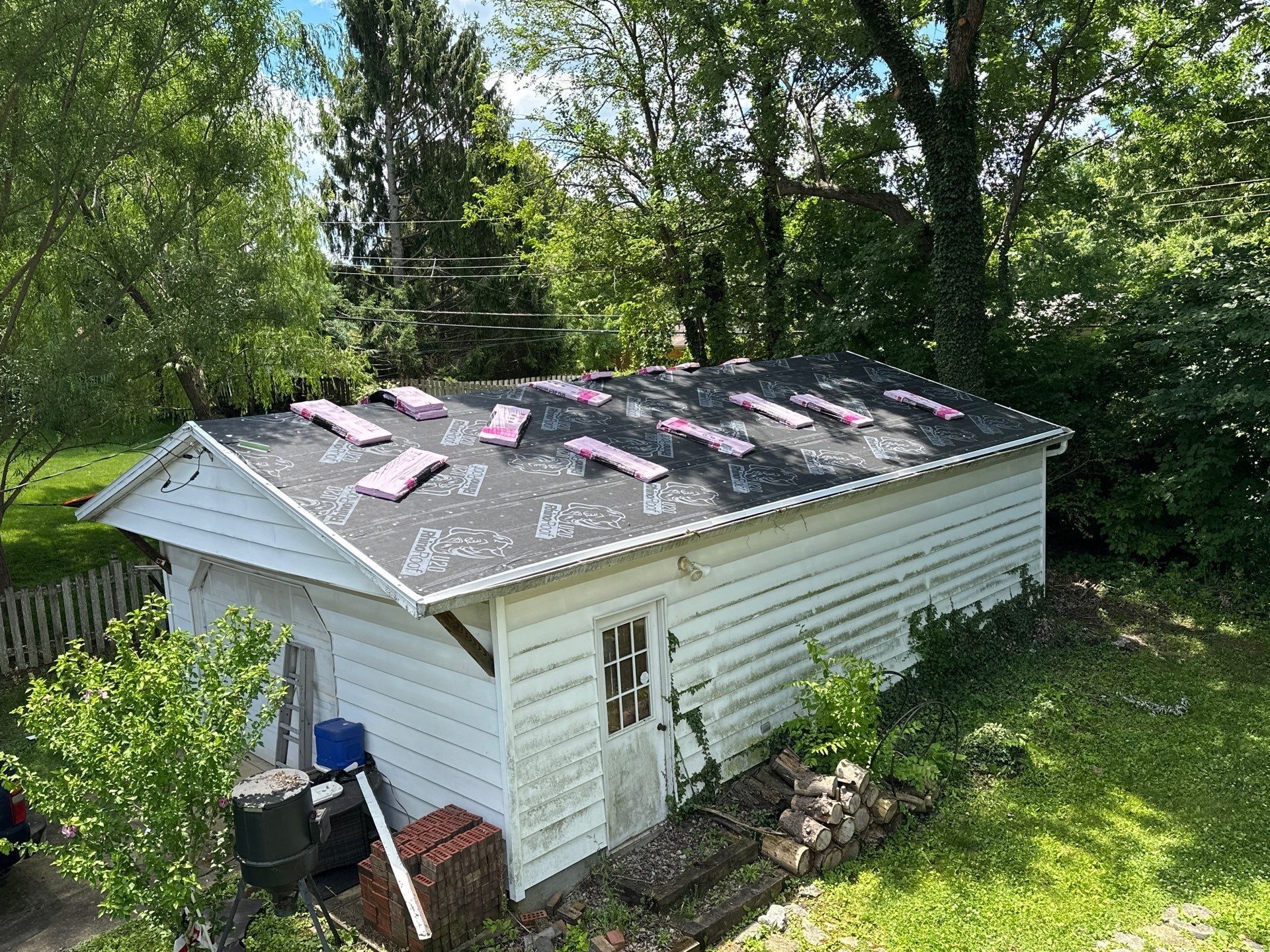 Clapboard outbuilding, RhinoRoof and pink bundles