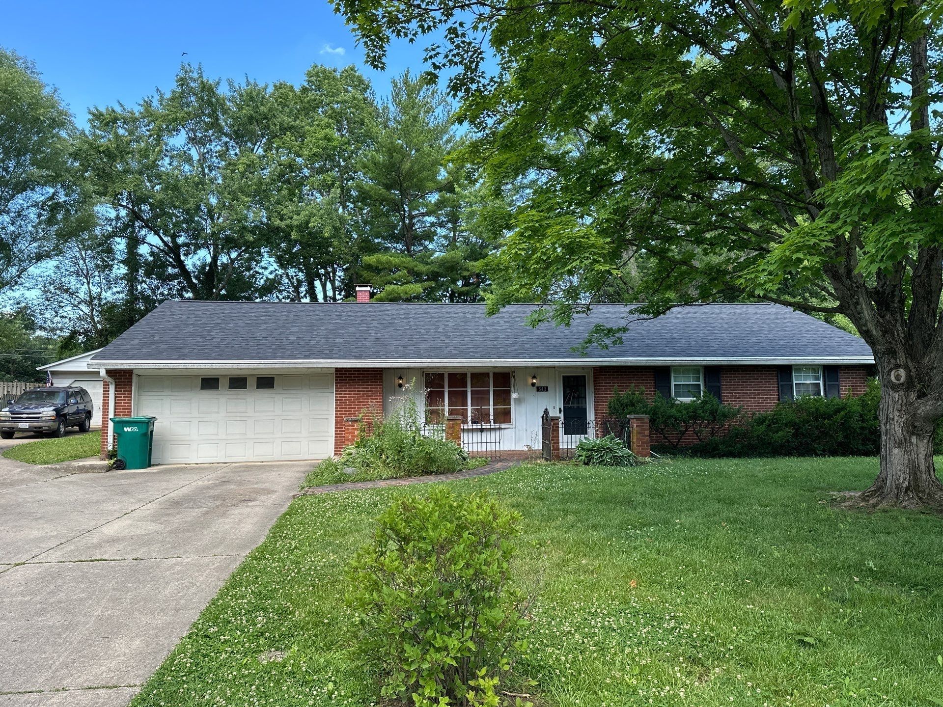 Brick ranch under a charcoal shingle roof