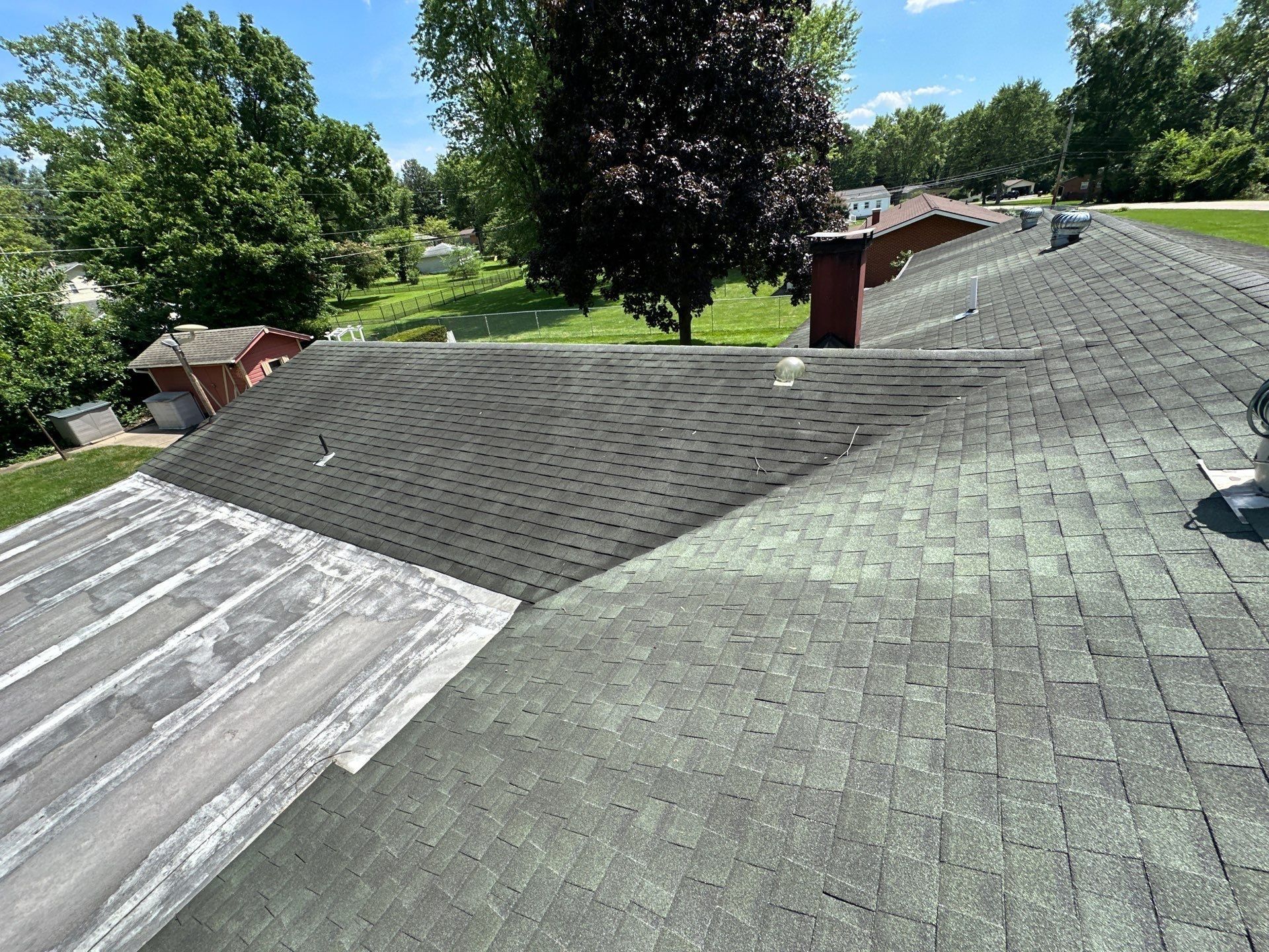 Old gray shingles, hips and turbine vents