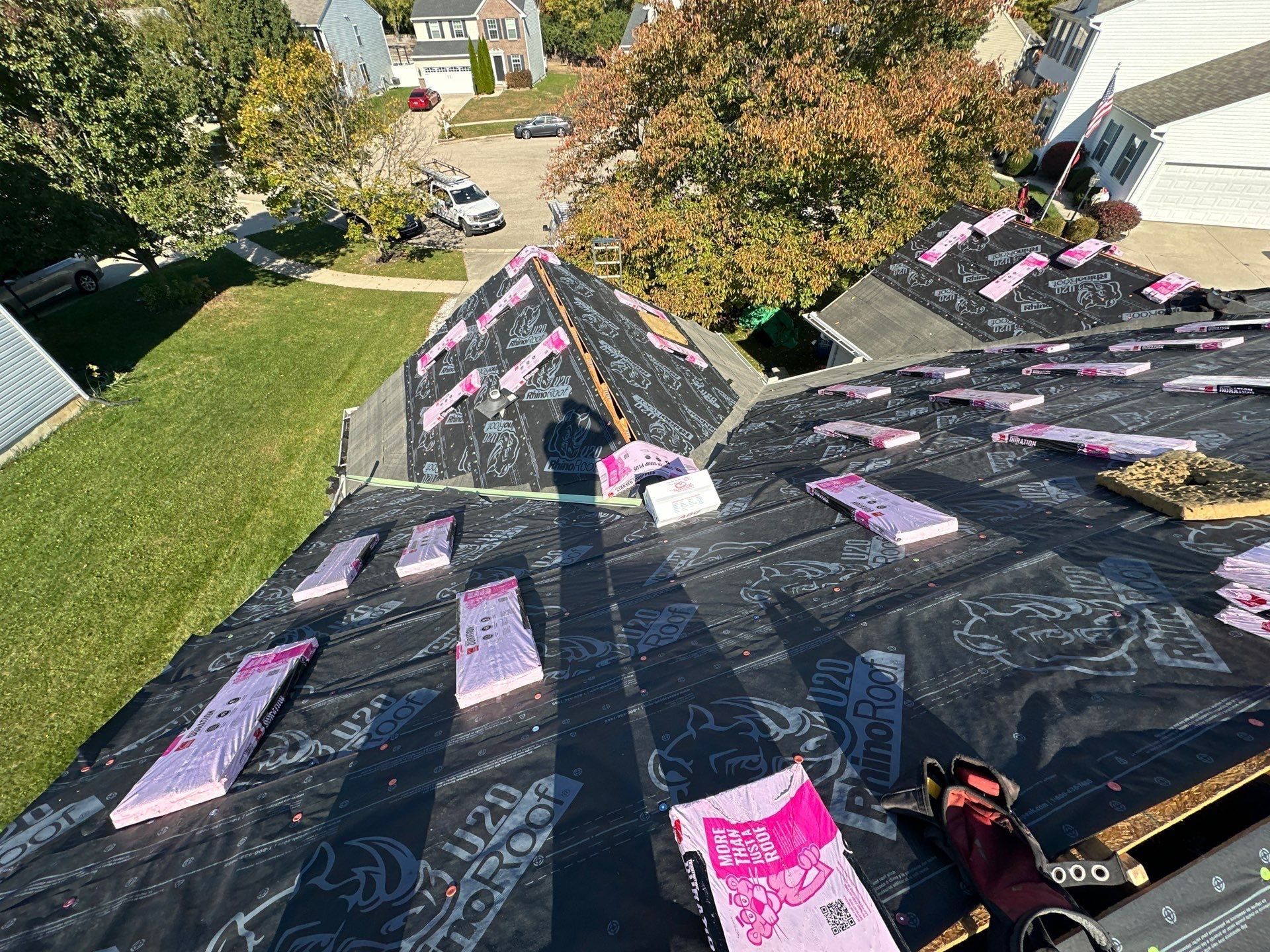 Bundles of shingles staged across the underlayment on the front slopes, Beavercreek, Ohio.