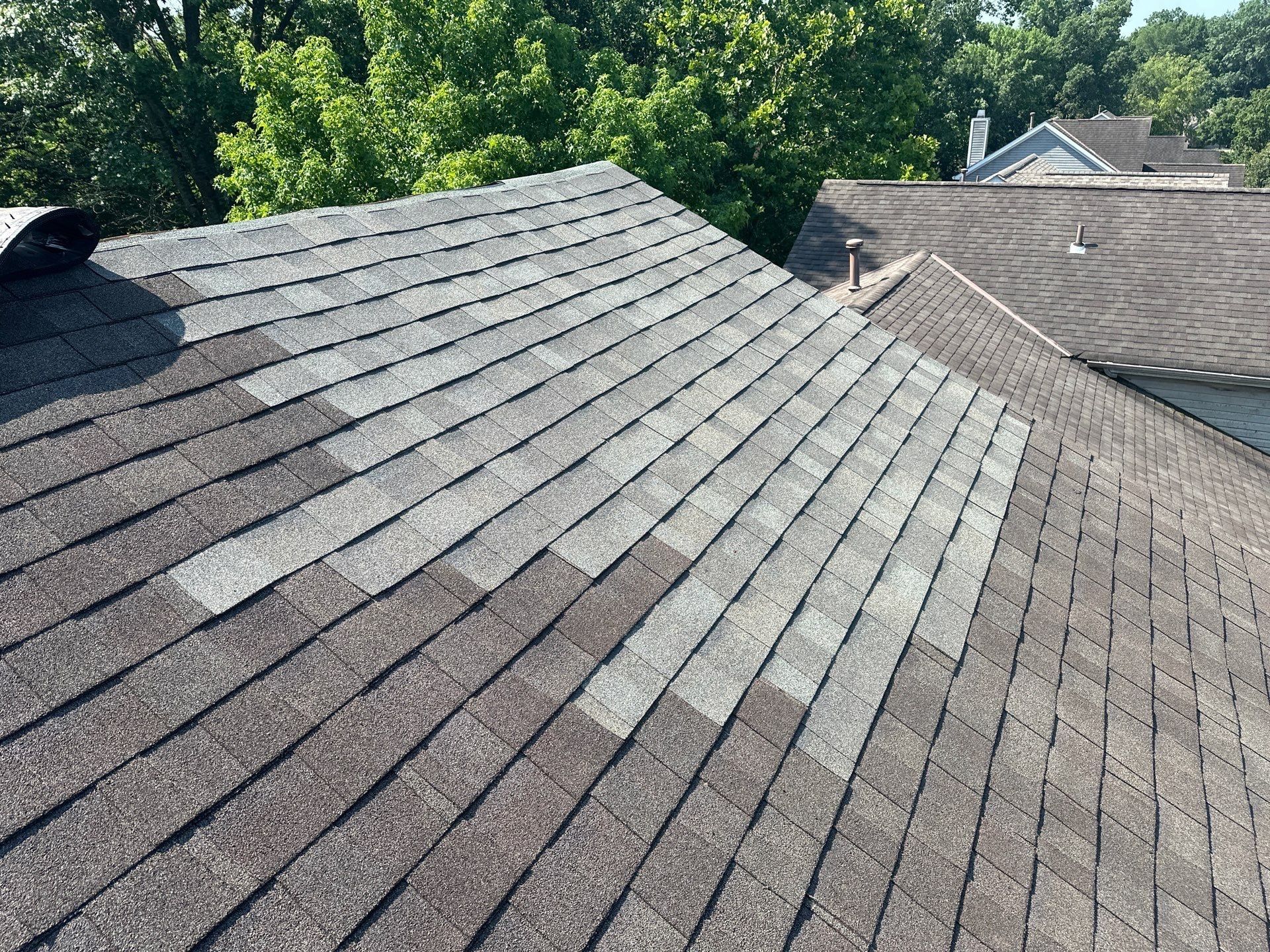 Mismatched new shingles across the repaired section of the roof, Kings Mills, Ohio.