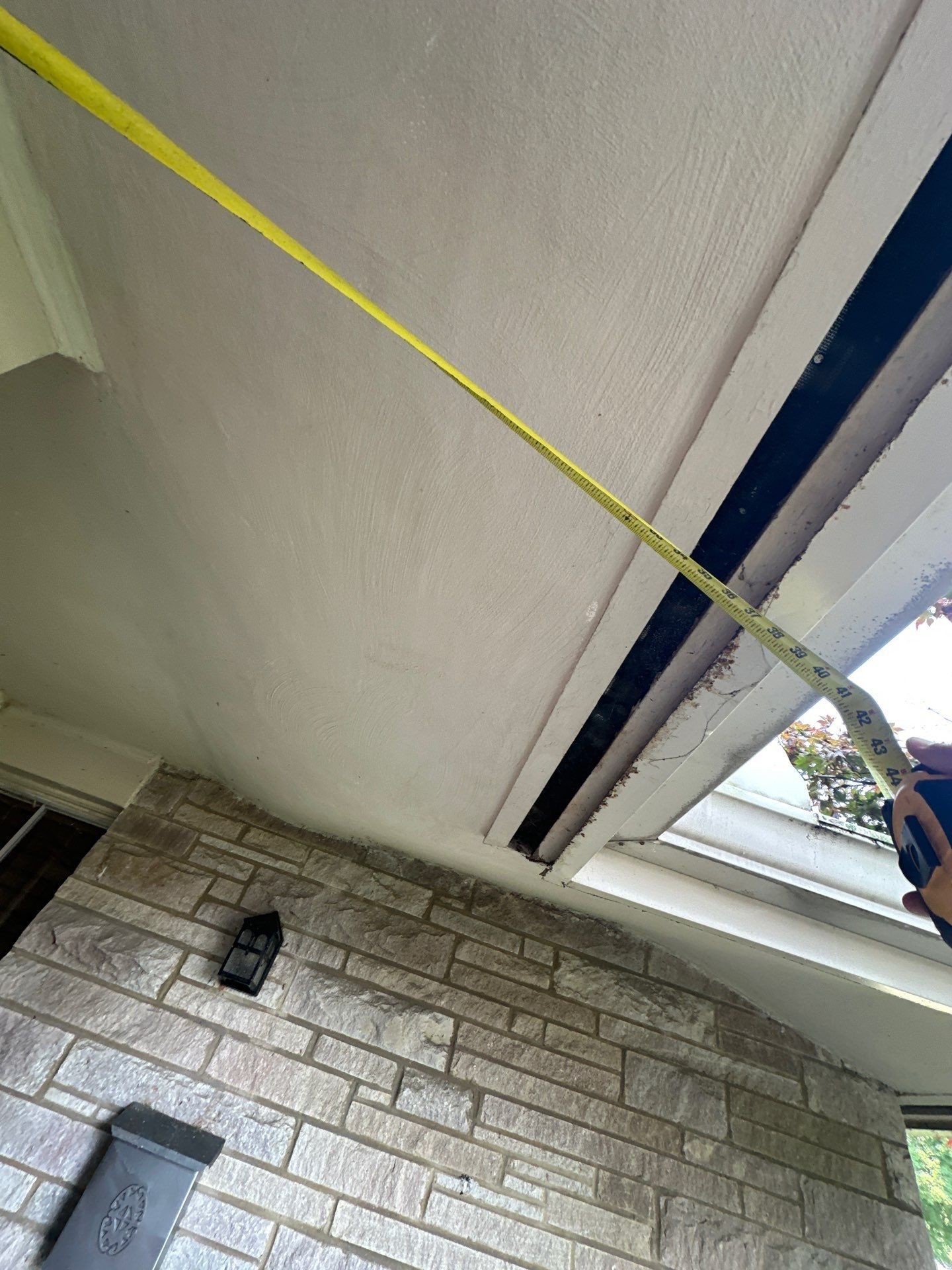 A tape measure run along the soffit to the corner, Kettering, Ohio.