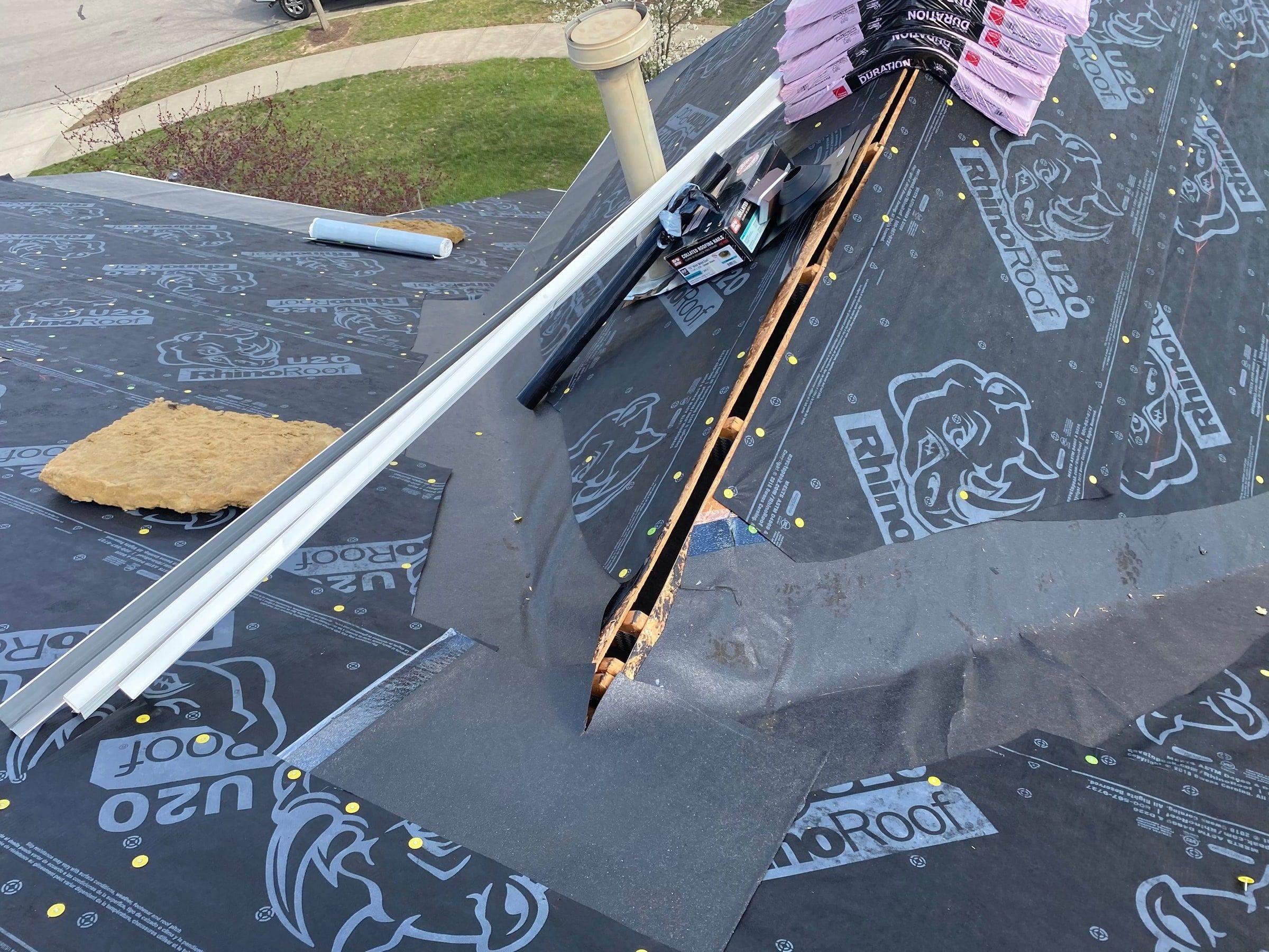 Ice and water shield laid in a roof valley between runs of synthetic underlayment, Xenia, Ohio.