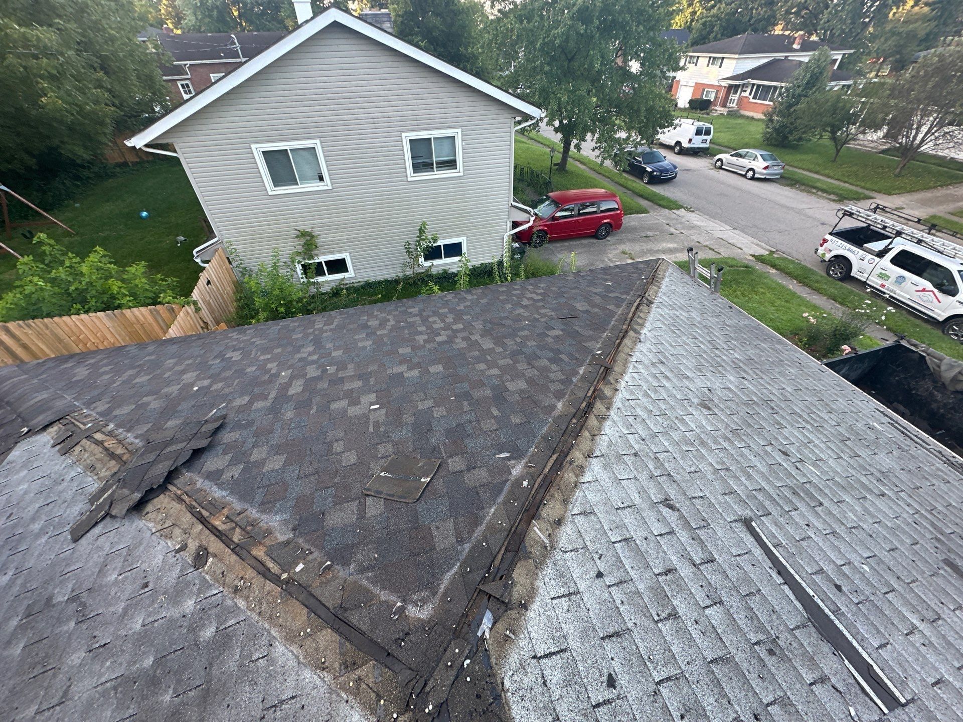 The top layer of shingles stripped along a hip, with the older layer below, Fairborn, Ohio.