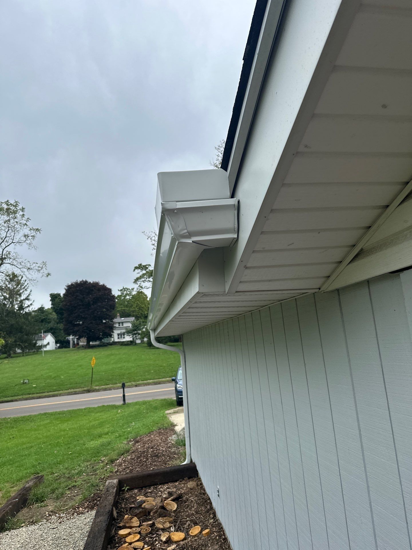 Looking up at the new gutter corner at the end of the garage eave.