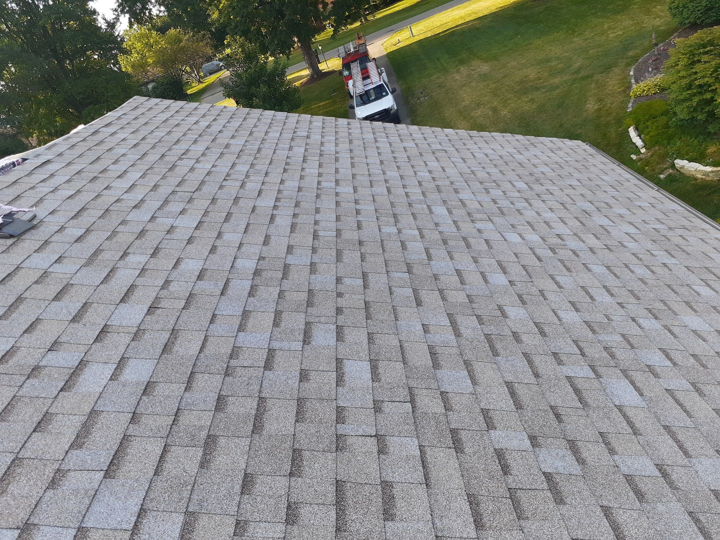 Shingled slope above the yard with the work truck below, Jamestown, Ohio.