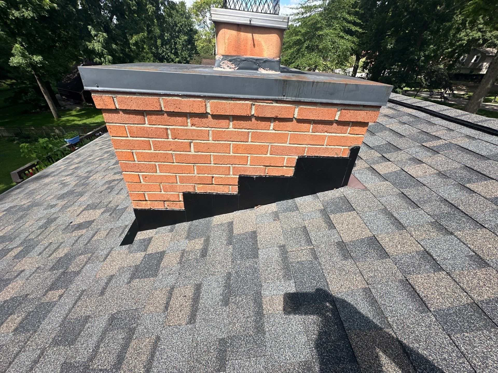 Stepped chimney flashing over the new shingles, Beavercreek, Ohio.