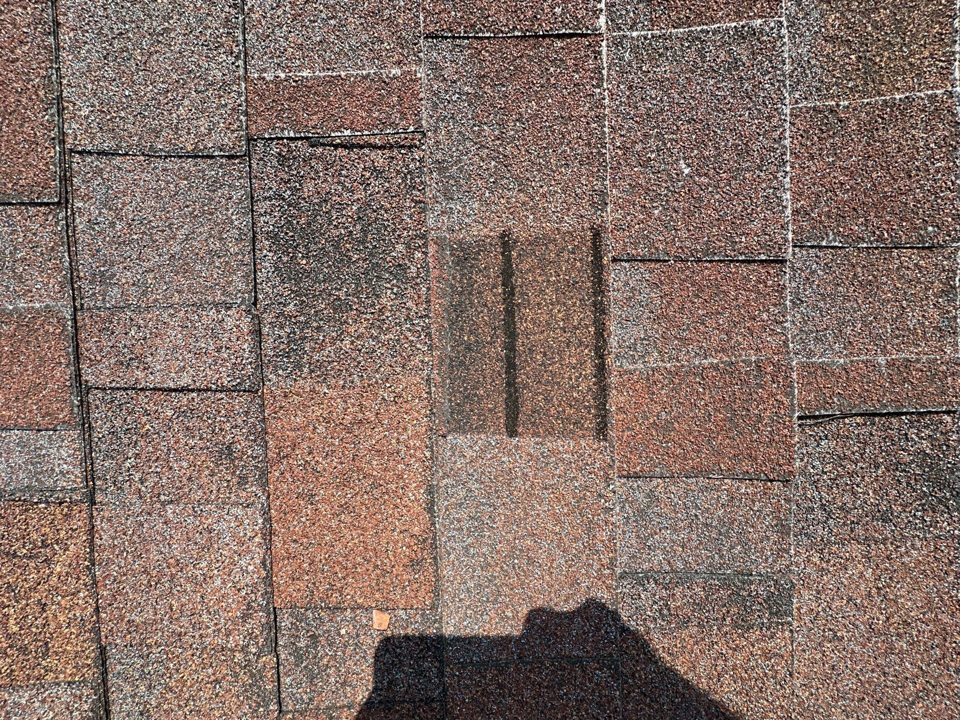 One damaged shingle tab among the older shingles, Kettering, Ohio.