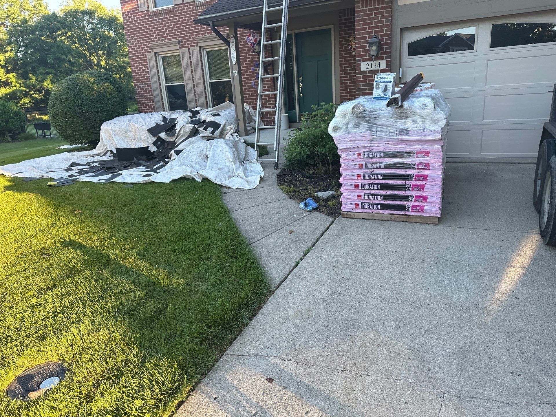 Tarps across the front lawn and drive