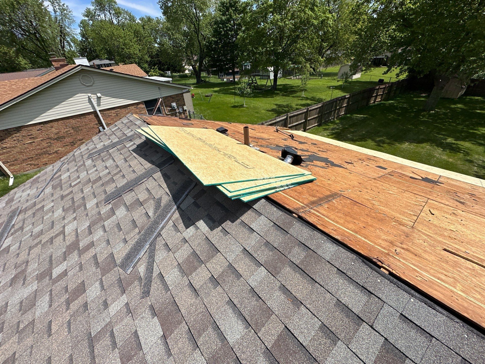 A stack of new OSB sheets on the finished front slope, ready for the back, Beavercreek, Ohio.