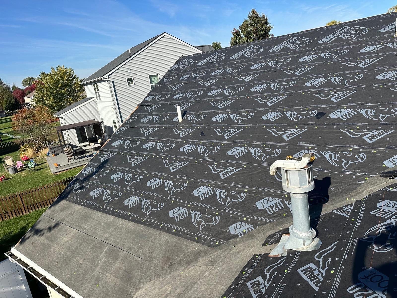 Ice and water shield along the eaves below the RhinoRoof underlayment, around a vent stack, Beavercreek, Ohio.