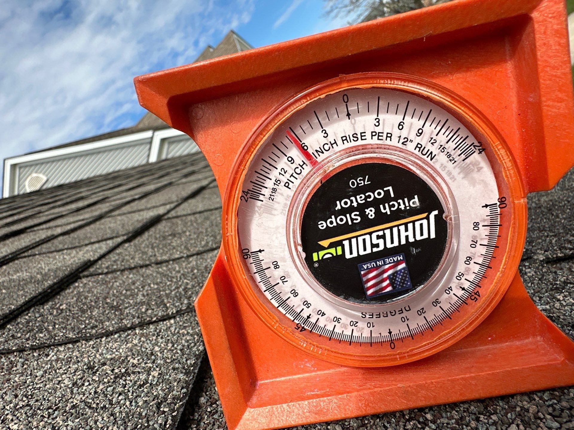Pitch gauge resting on the shingles