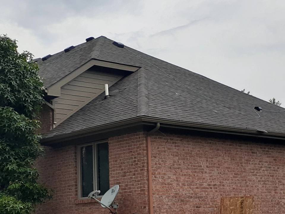 The new shingles on the back of the large brick home, Xenia, Ohio.