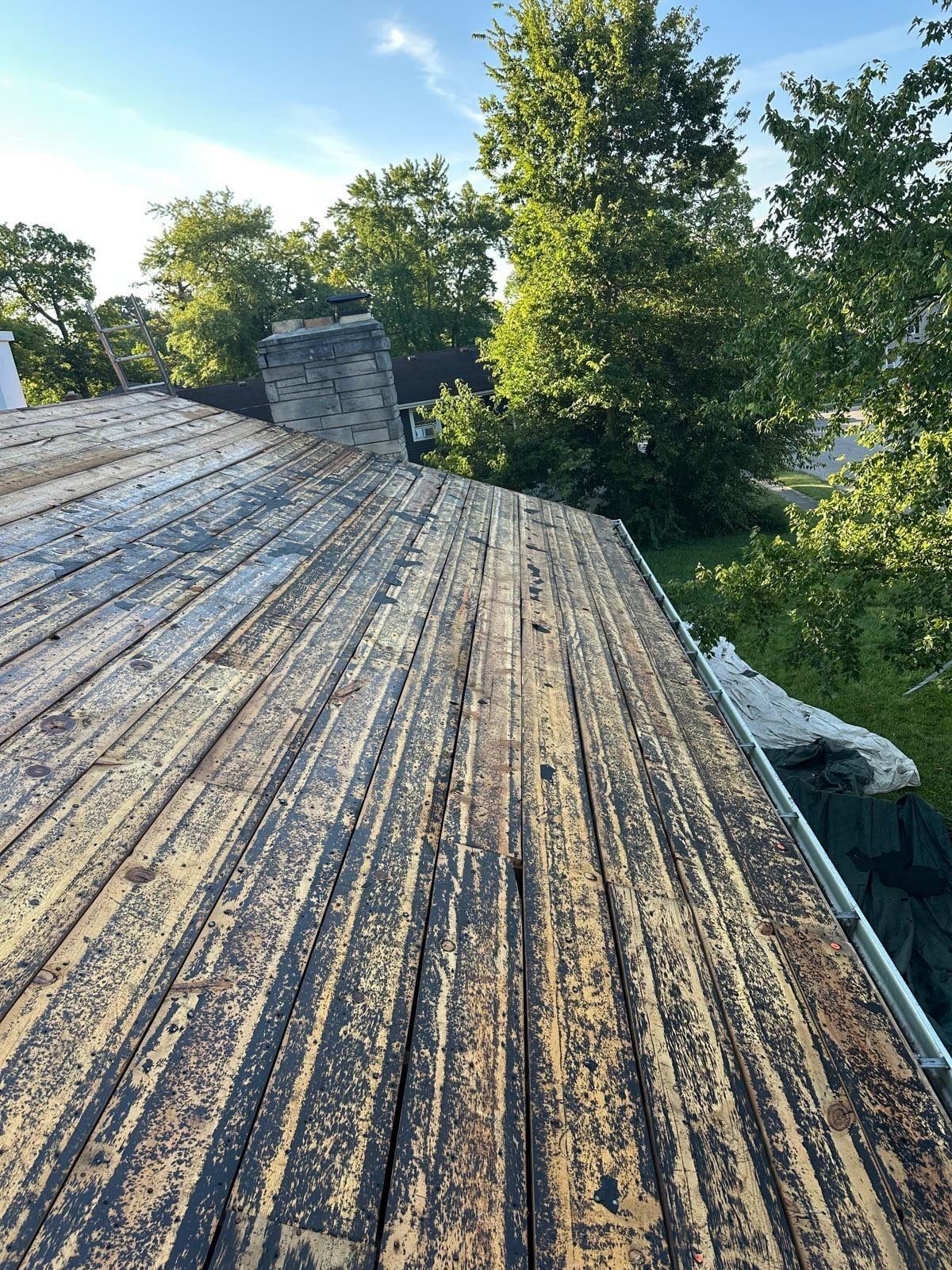 Weathered boards running along the roof toward the stone chimney, Fairborn, Ohio.