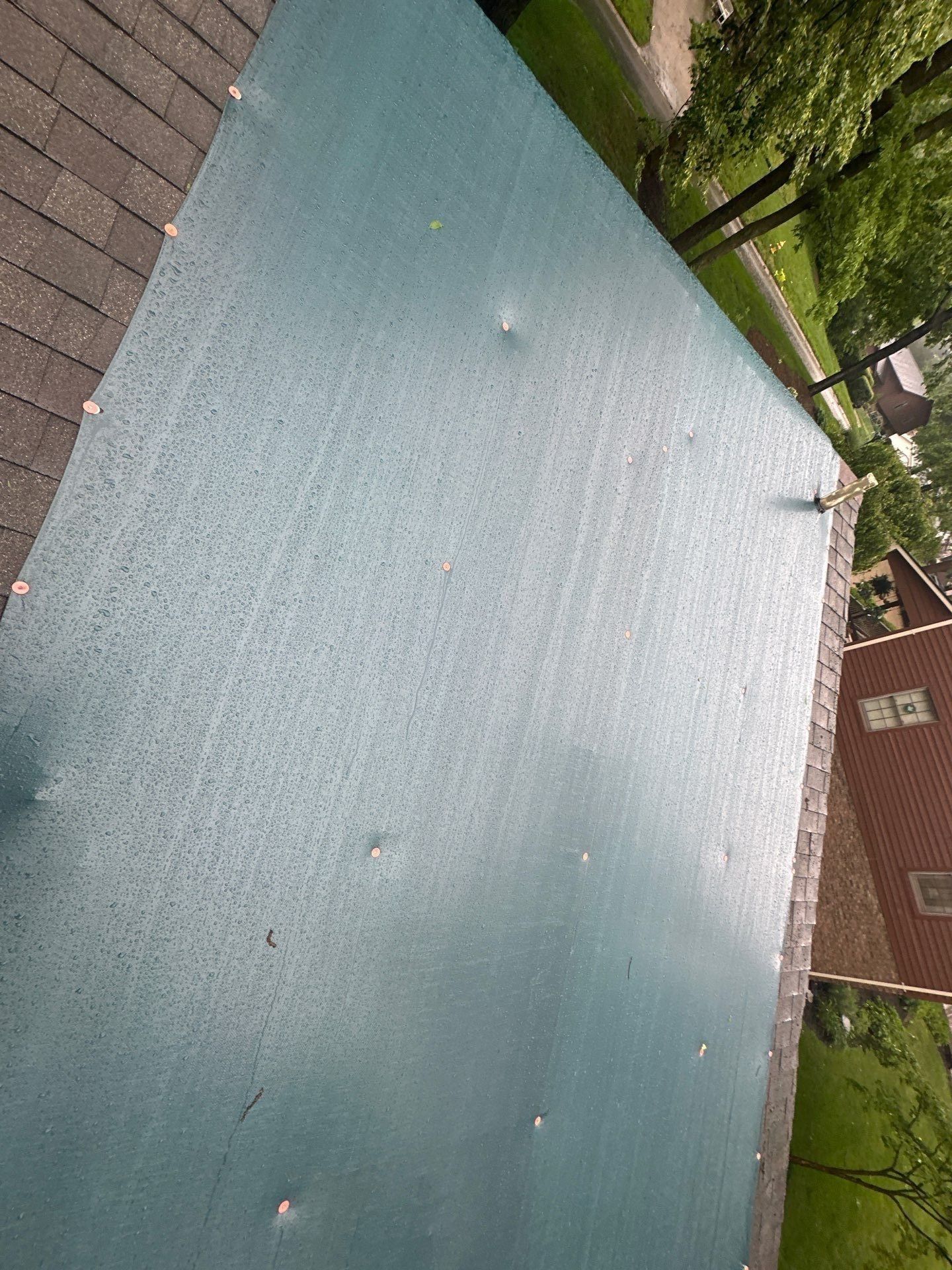 Teal tarp to the roof edge