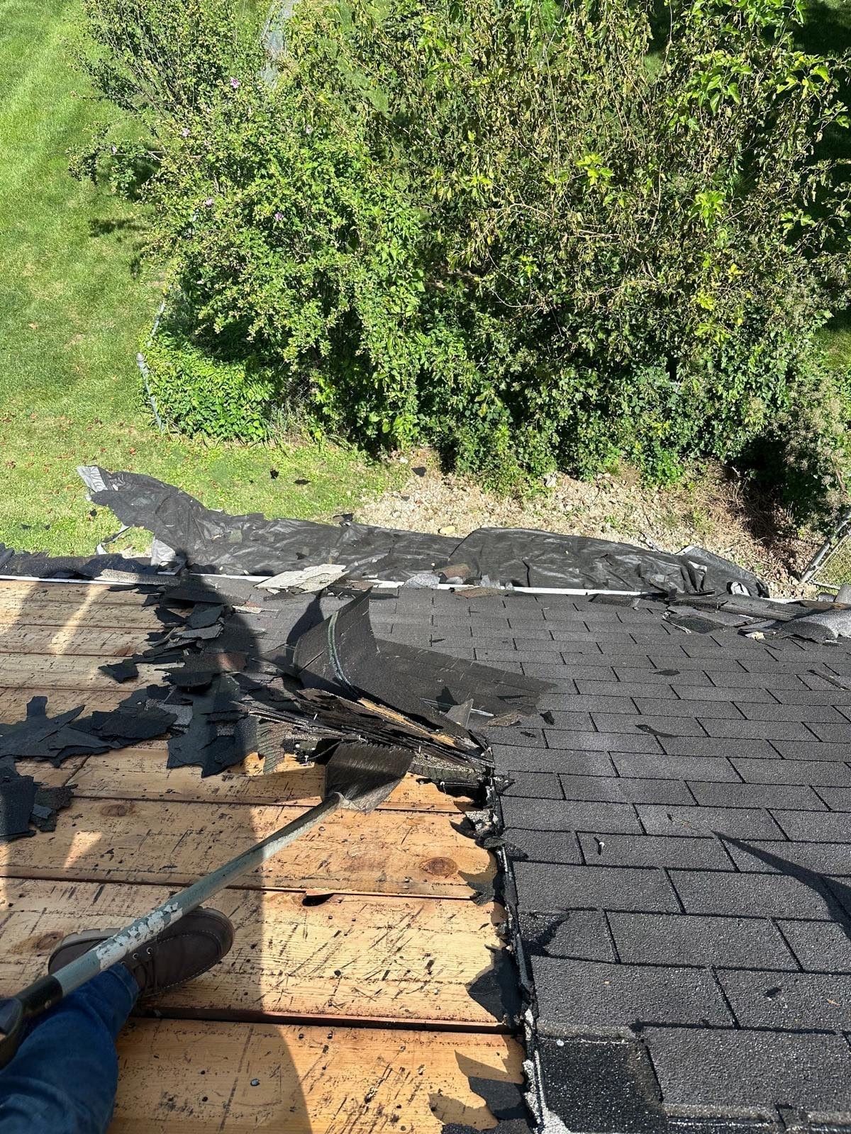 Stacked layers of old shingles being pried off the deck boards, Beavercreek, Ohio.
