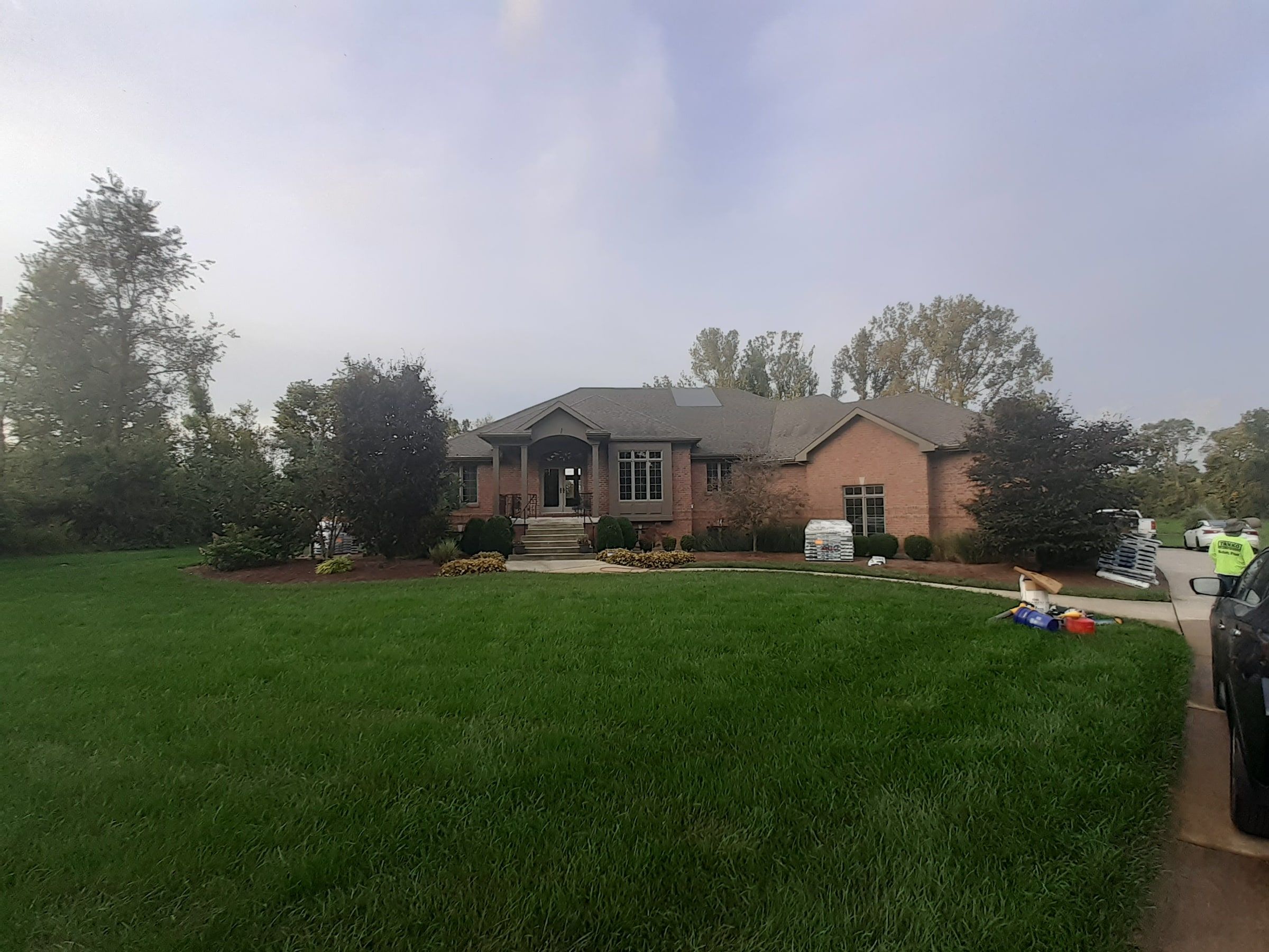 Brick house from the lawn in mist
