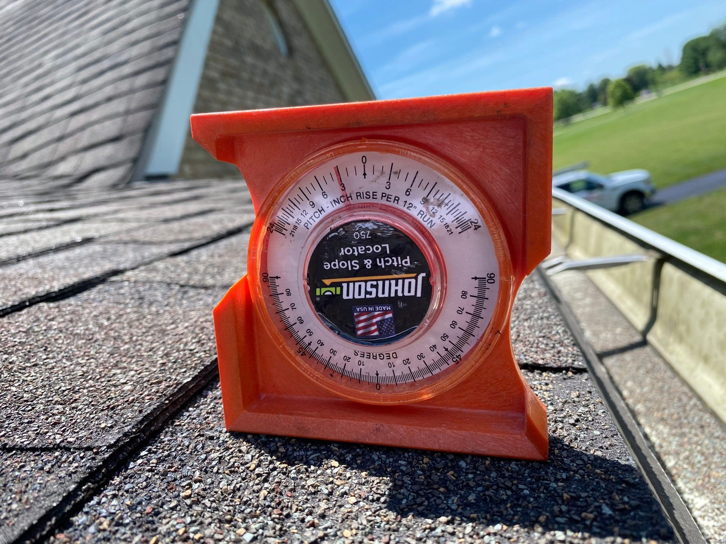 Pitch gauge set on the old shingles to measure the roof slope, Yellow Springs, Ohio.